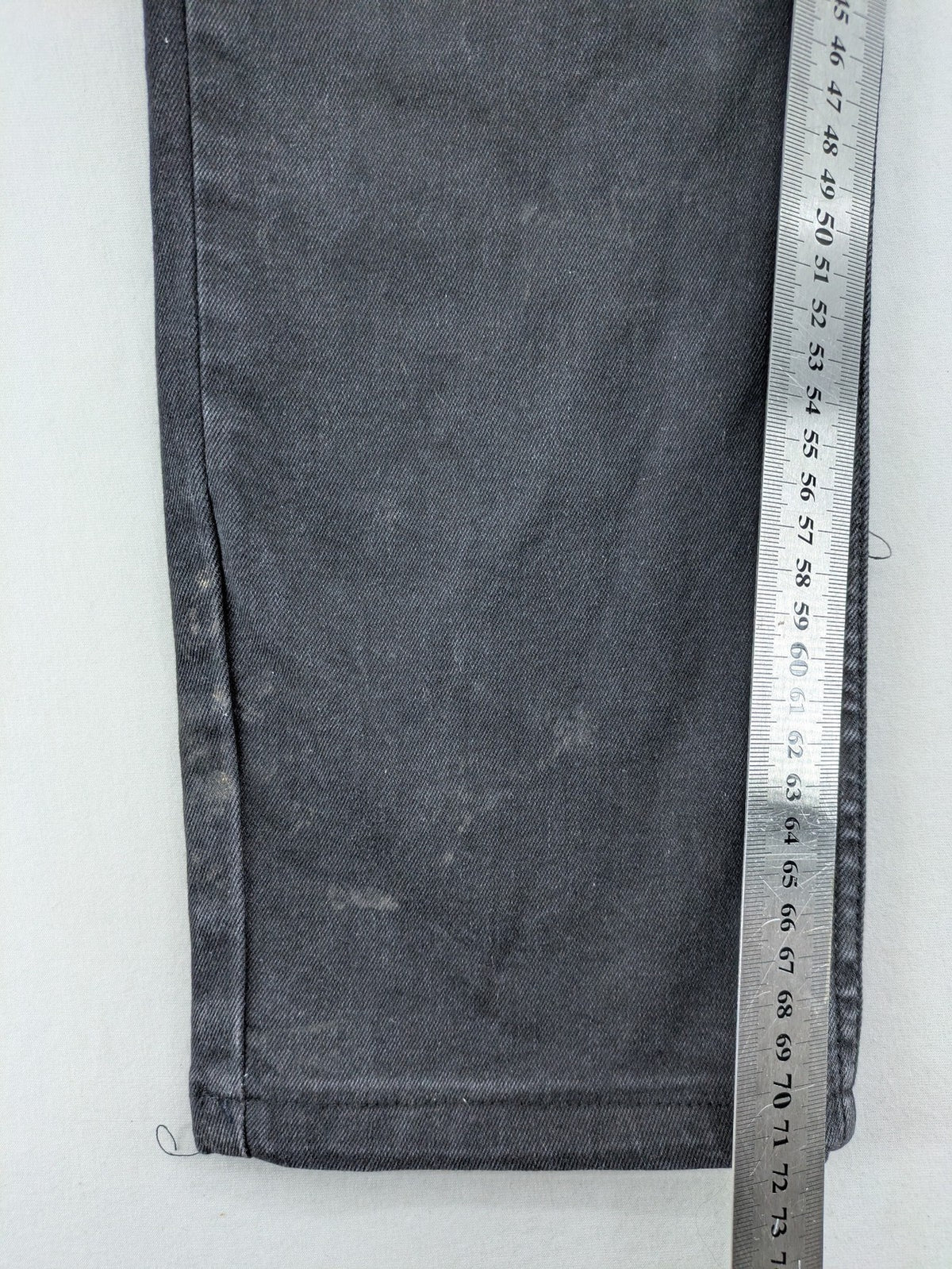Philipp Plein black straight jeans with distressed finish and skull patch detail.