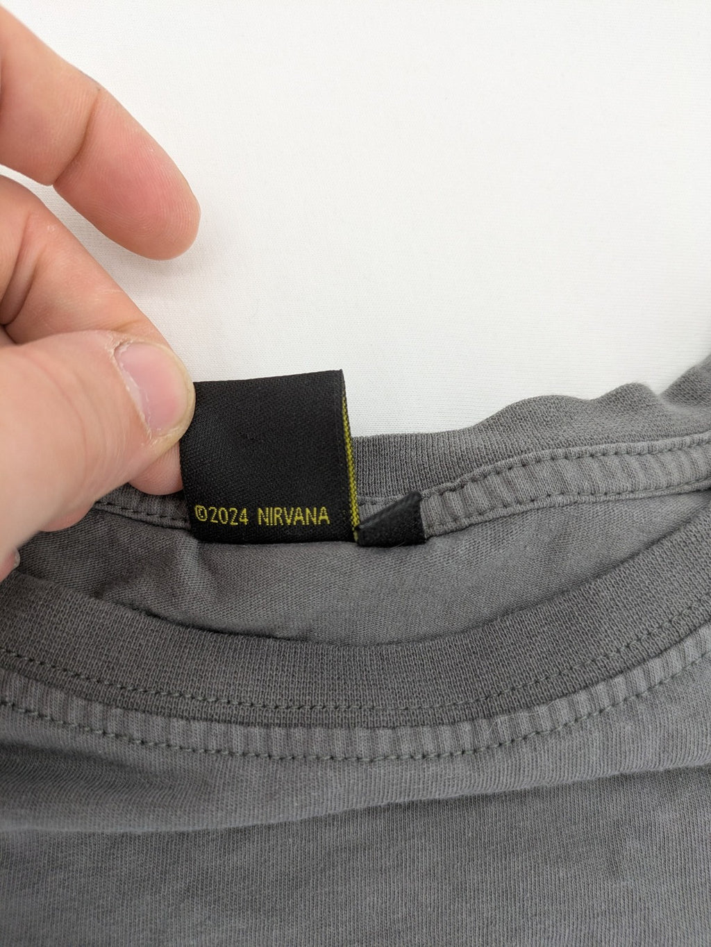 Nirvana grey t-shirt with rainbow Smiley logo and "Come As You Are" text.