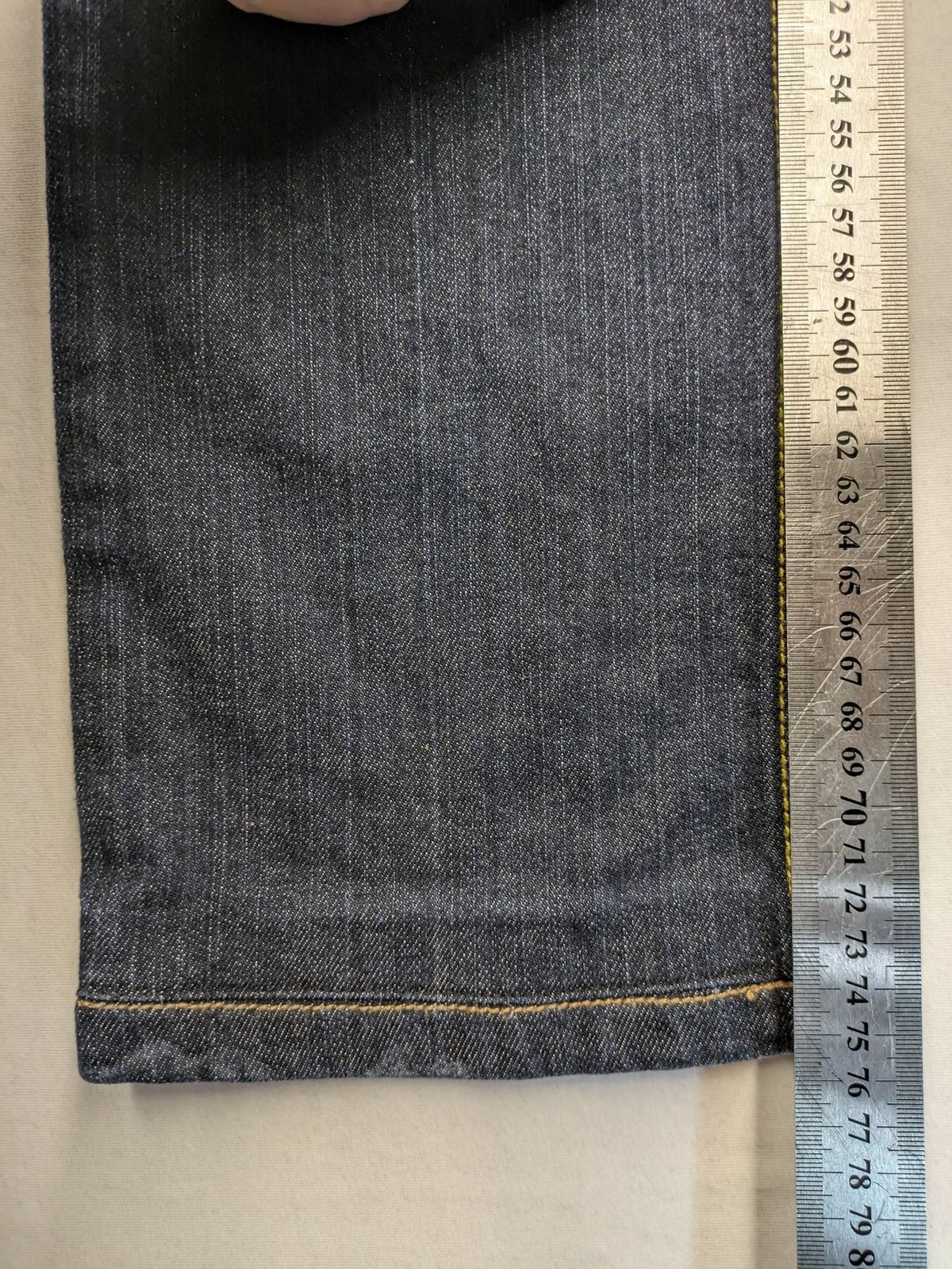 Furore blue straight jeans with yellow contrast stitching and zipper details.