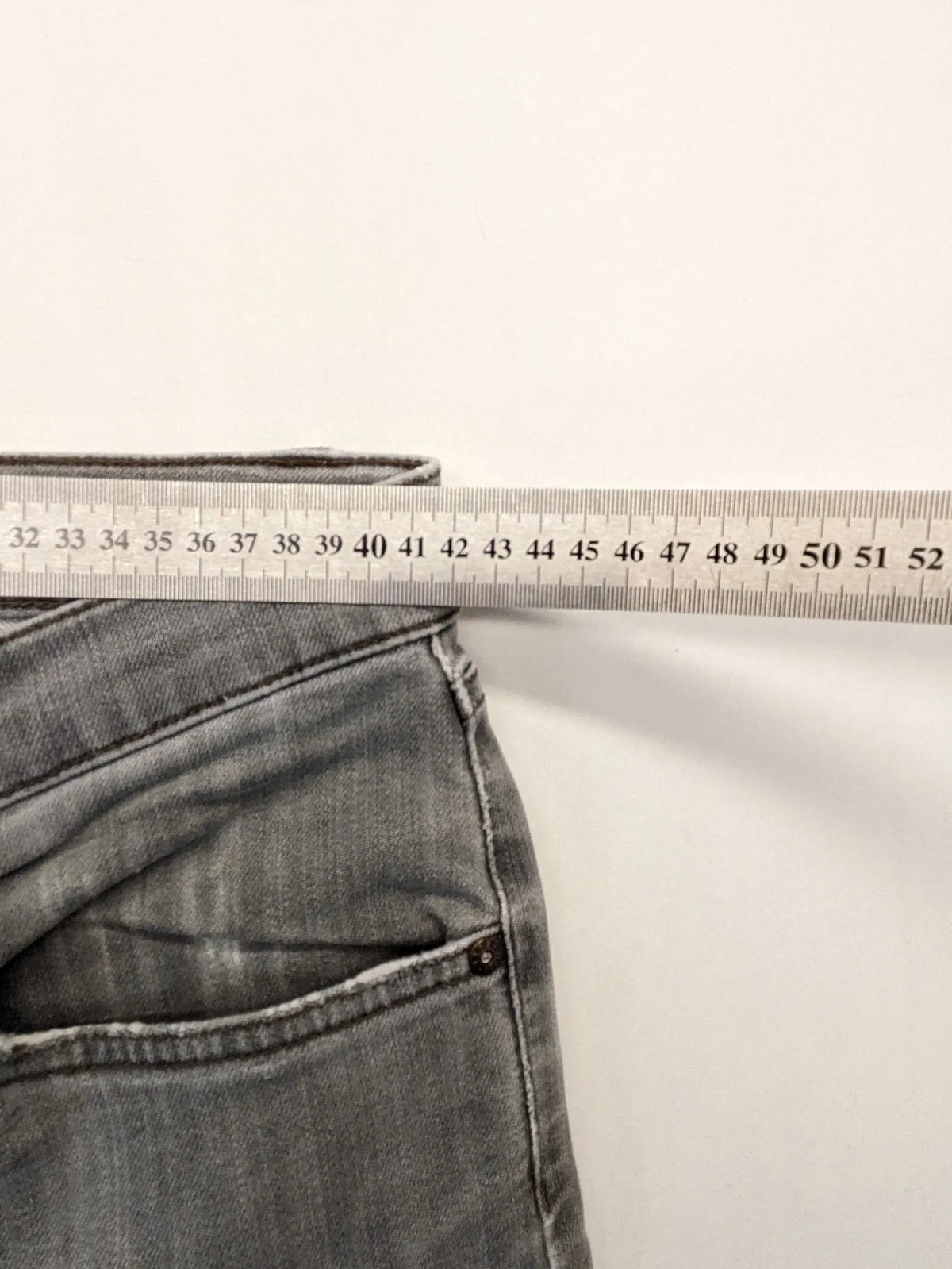 BRAX grey straight jeans with classic 5-pocket style and washed denim finish.