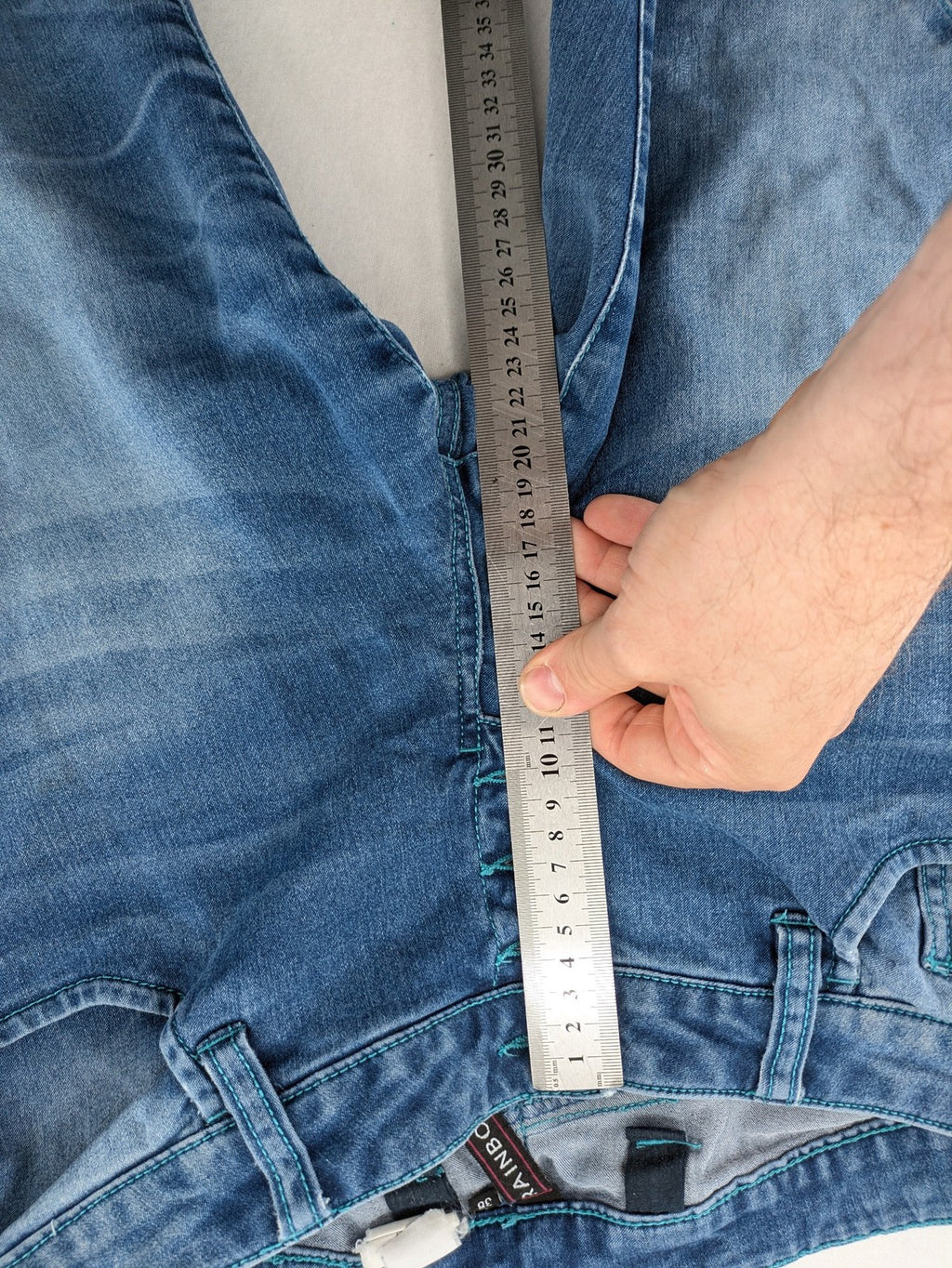 Rainbow blue straight jeans jogger style with button fly and contrasting turquoise stitching.