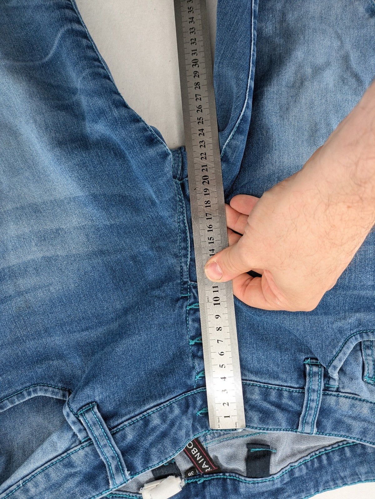 Rainbow blue straight jeans jogger style with button fly and contrasting turquoise stitching.