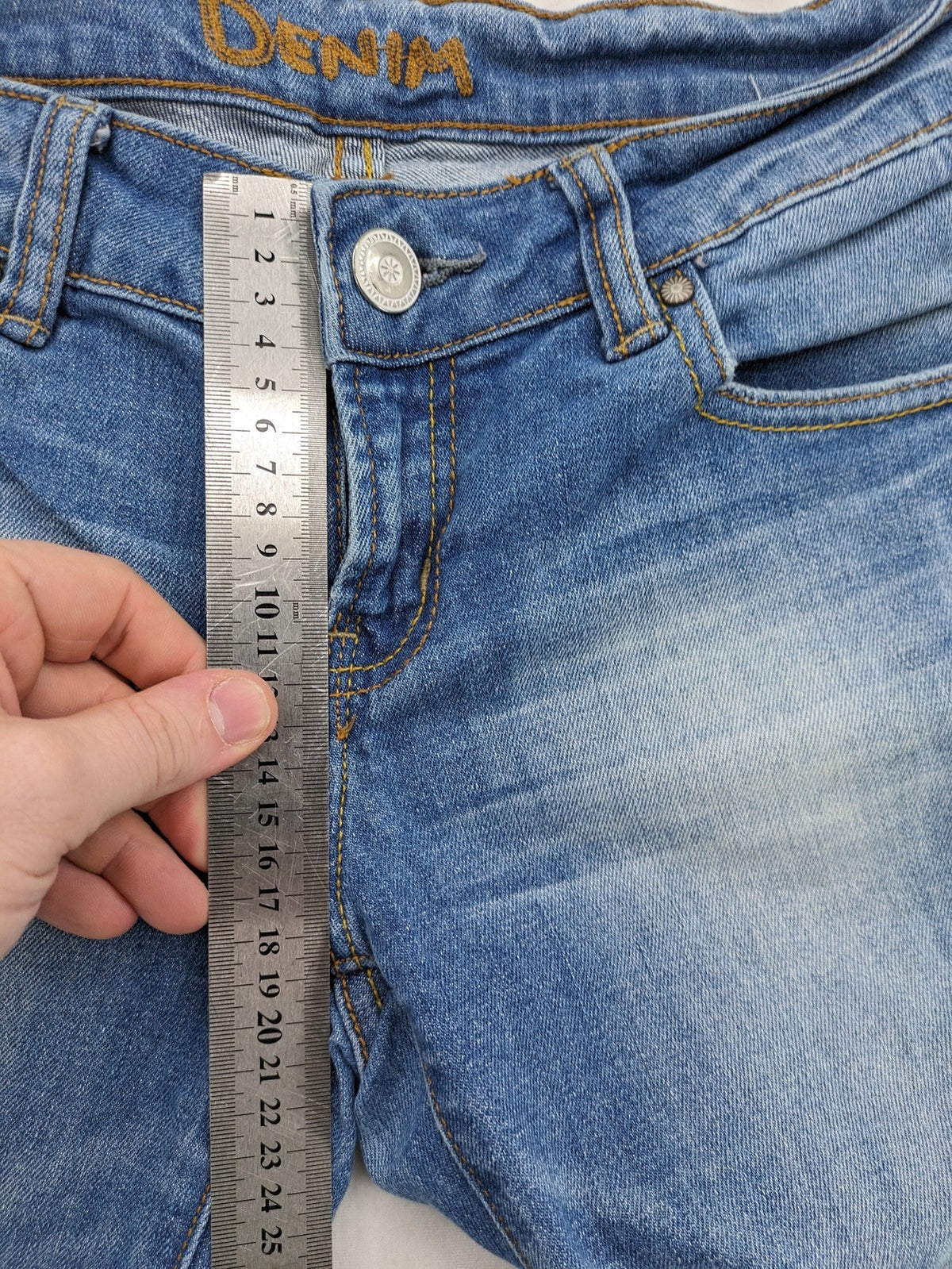 Denim blue straight jeans low rise bootcut with classic 5-pocket design and subtle rivets.