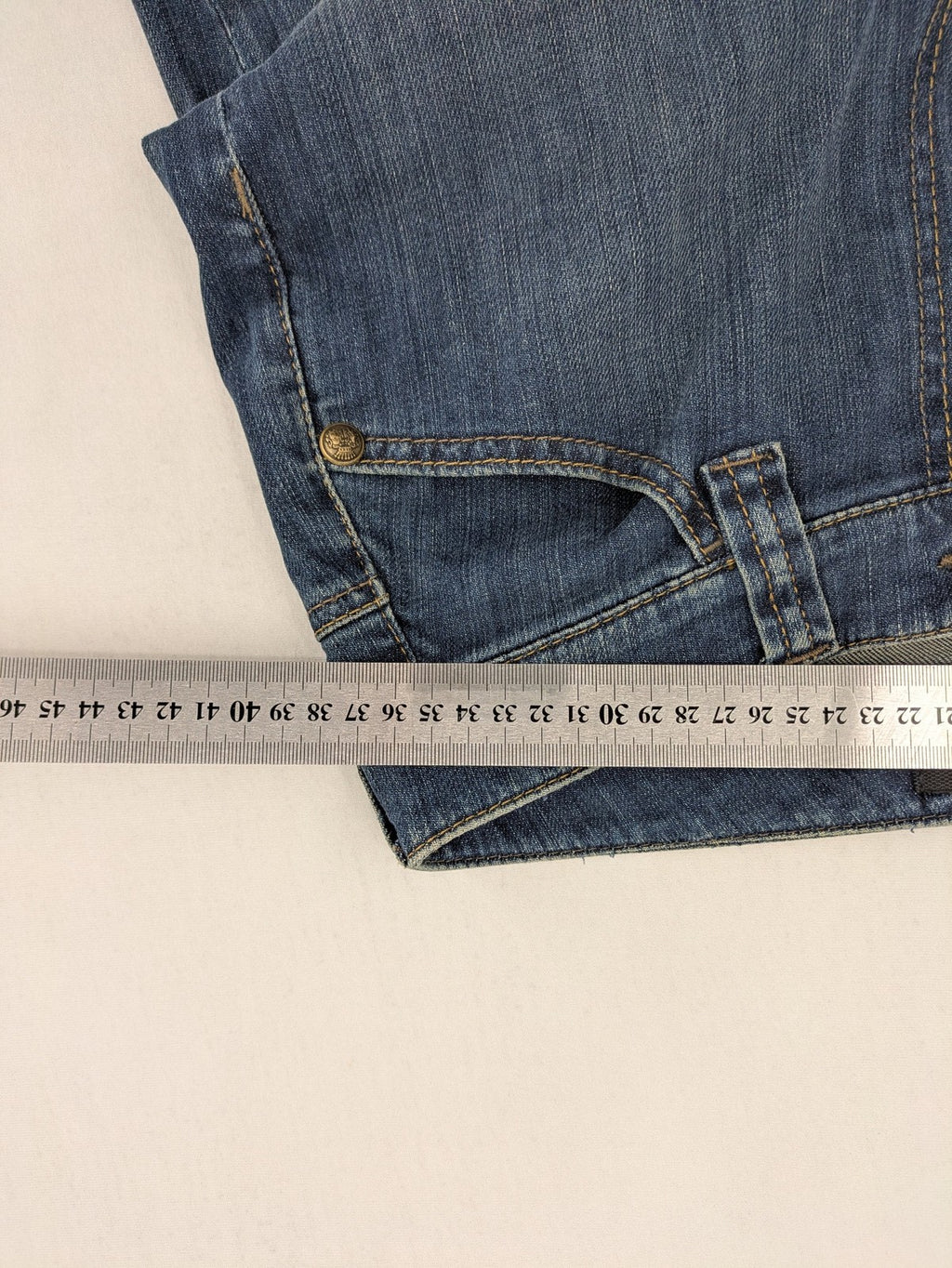 Rosner blue wide leg jeans with colorful embroidery on back pockets.