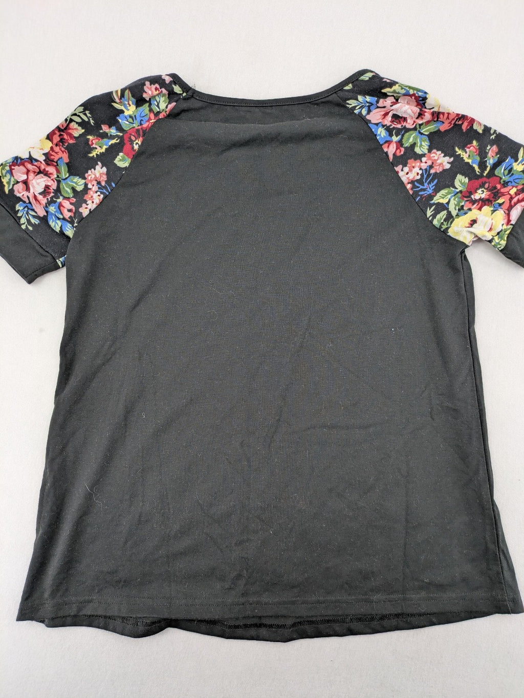Emery Rose pink T-shirt with floral raglan sleeves and round neckline.