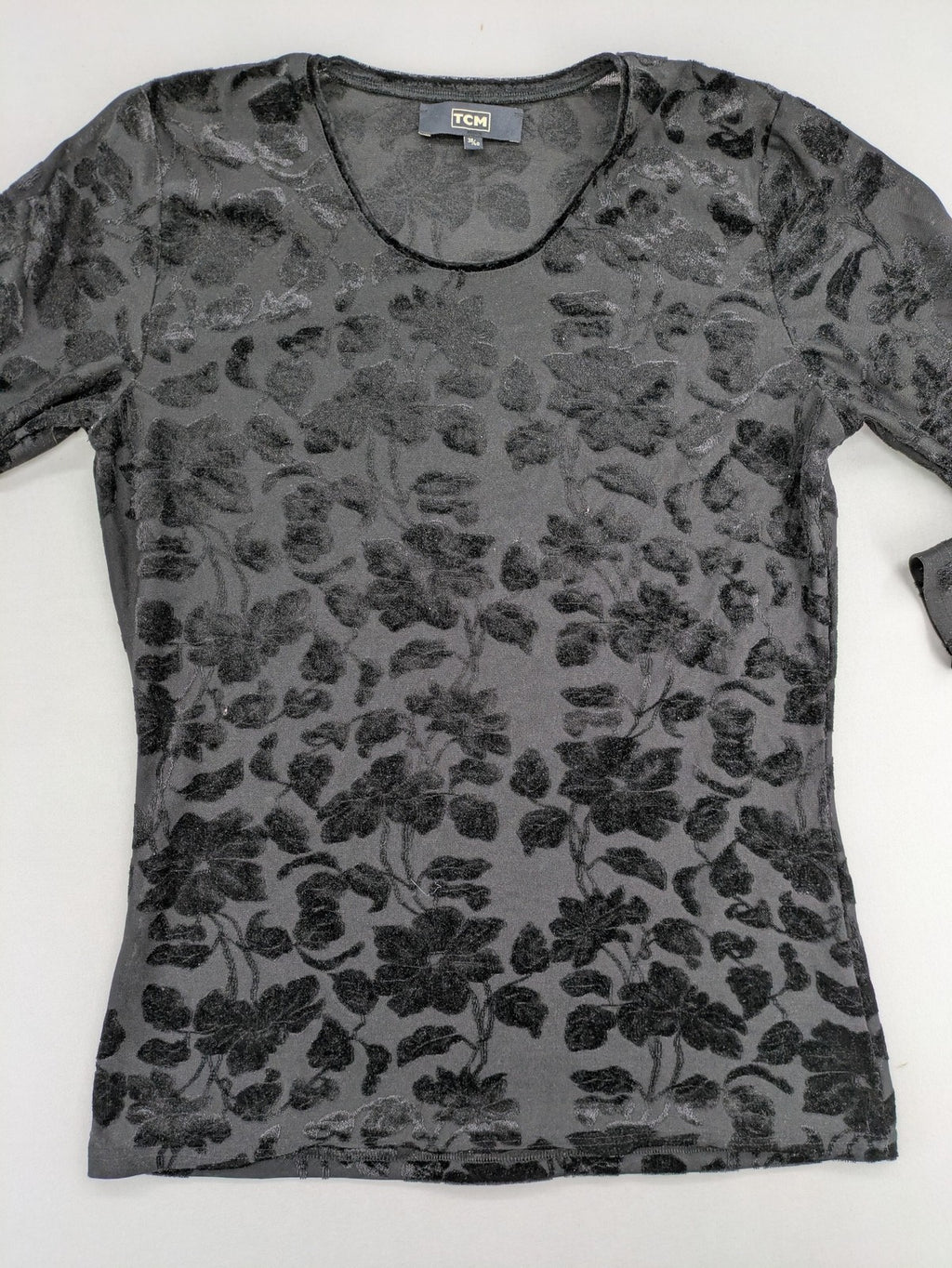 TCM black long sleeve top with floral flock print on sheer fabric.