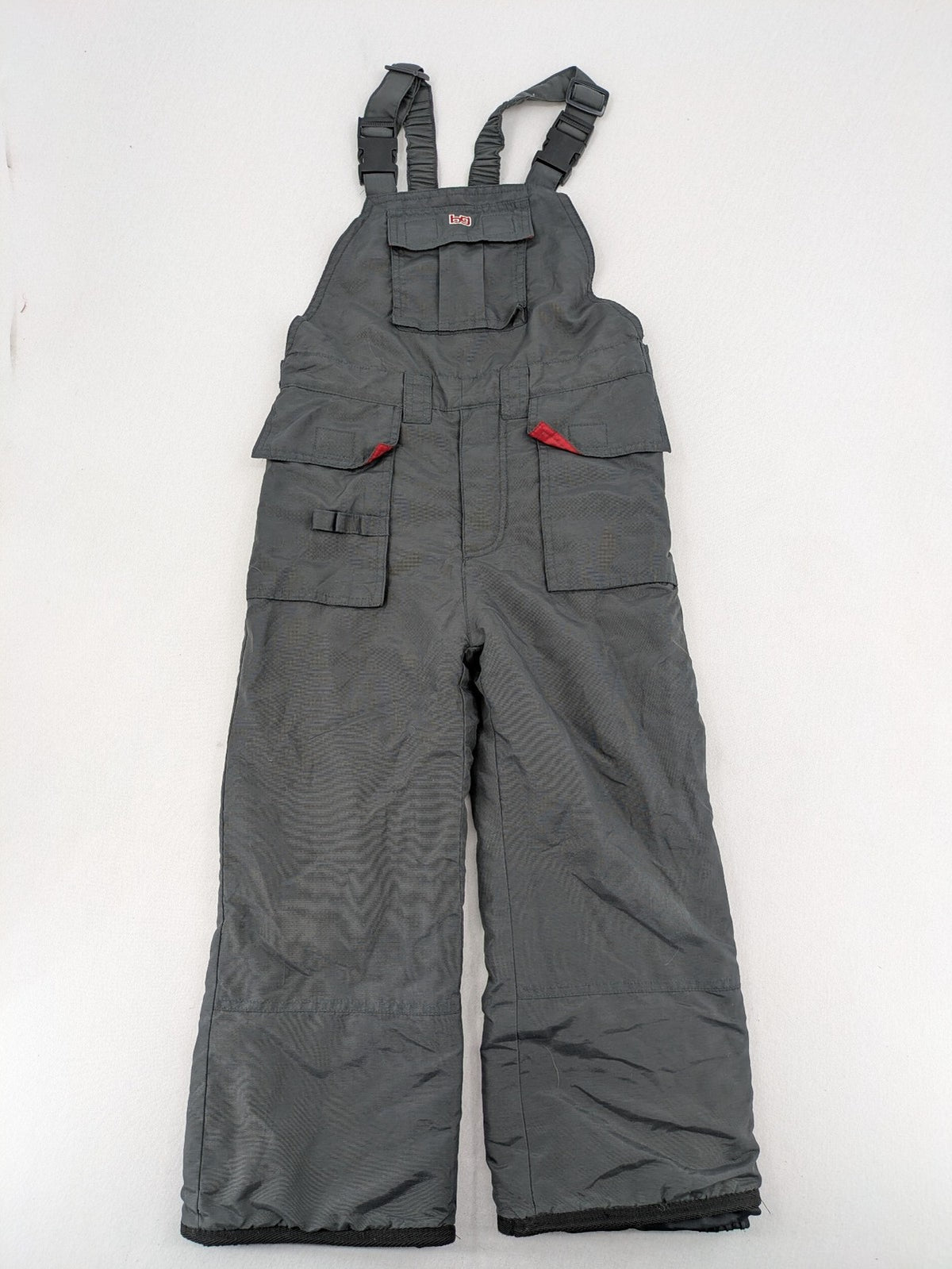 H&M grey snow pants with red accents, adjustable straps, and multiple cargo pockets.