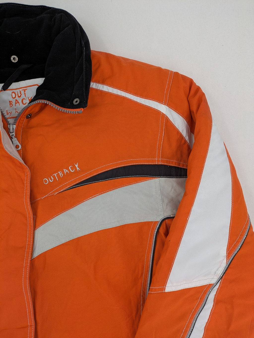 Outback orange outdoor jacket size 42 with reflective accents and mixed color details.