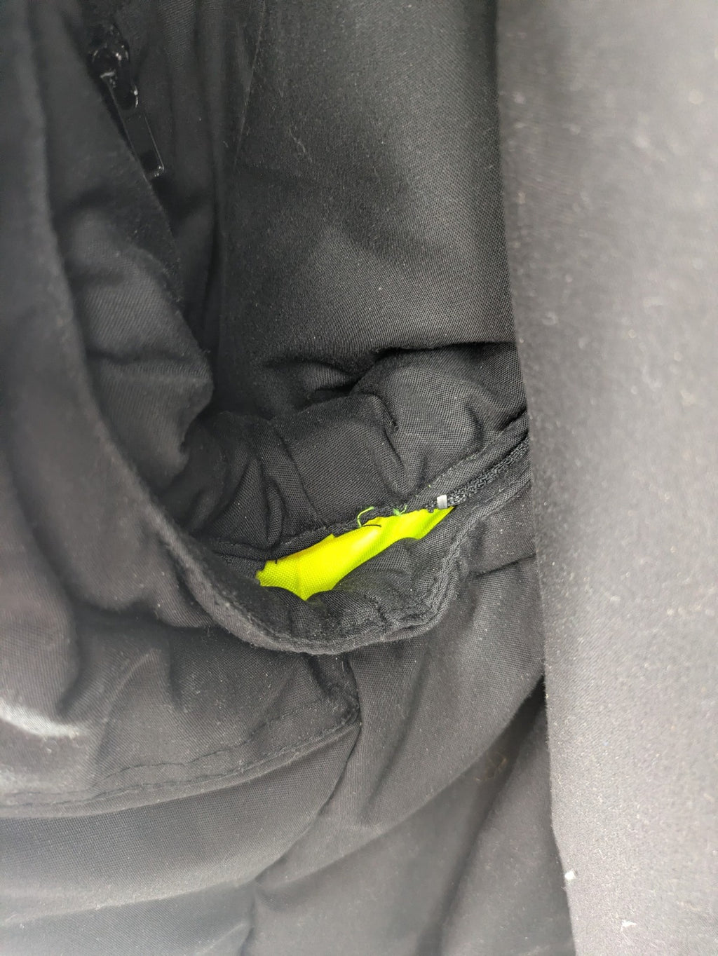 Hüren OHG grey and neon yellow safety jacket with reflective stripes and zippered arm pocket.