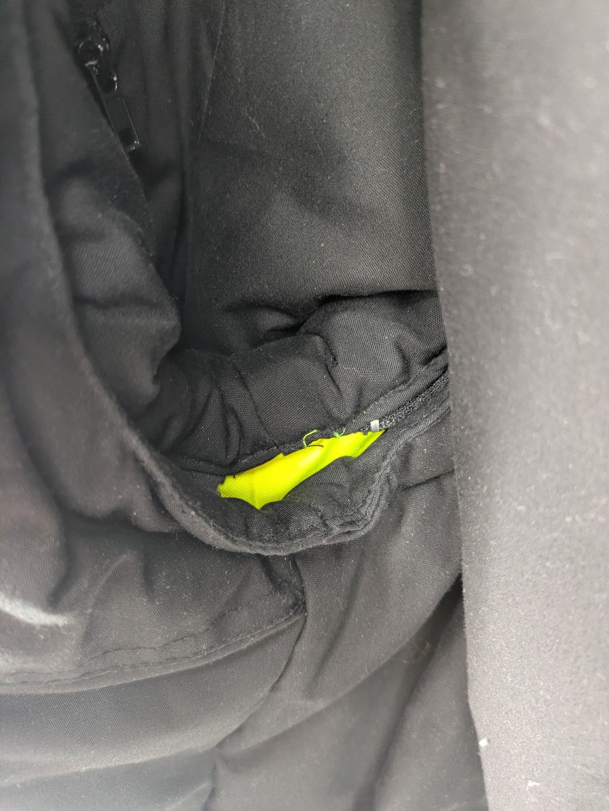 Hüren OHG grey and neon yellow safety jacket with reflective stripes and zippered arm pocket.