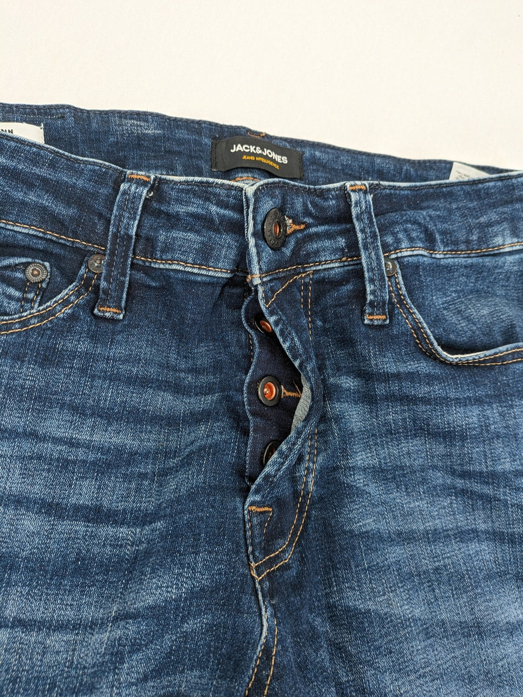Jack & Jones blue slim fit jeans with faded wash and classic button fly.