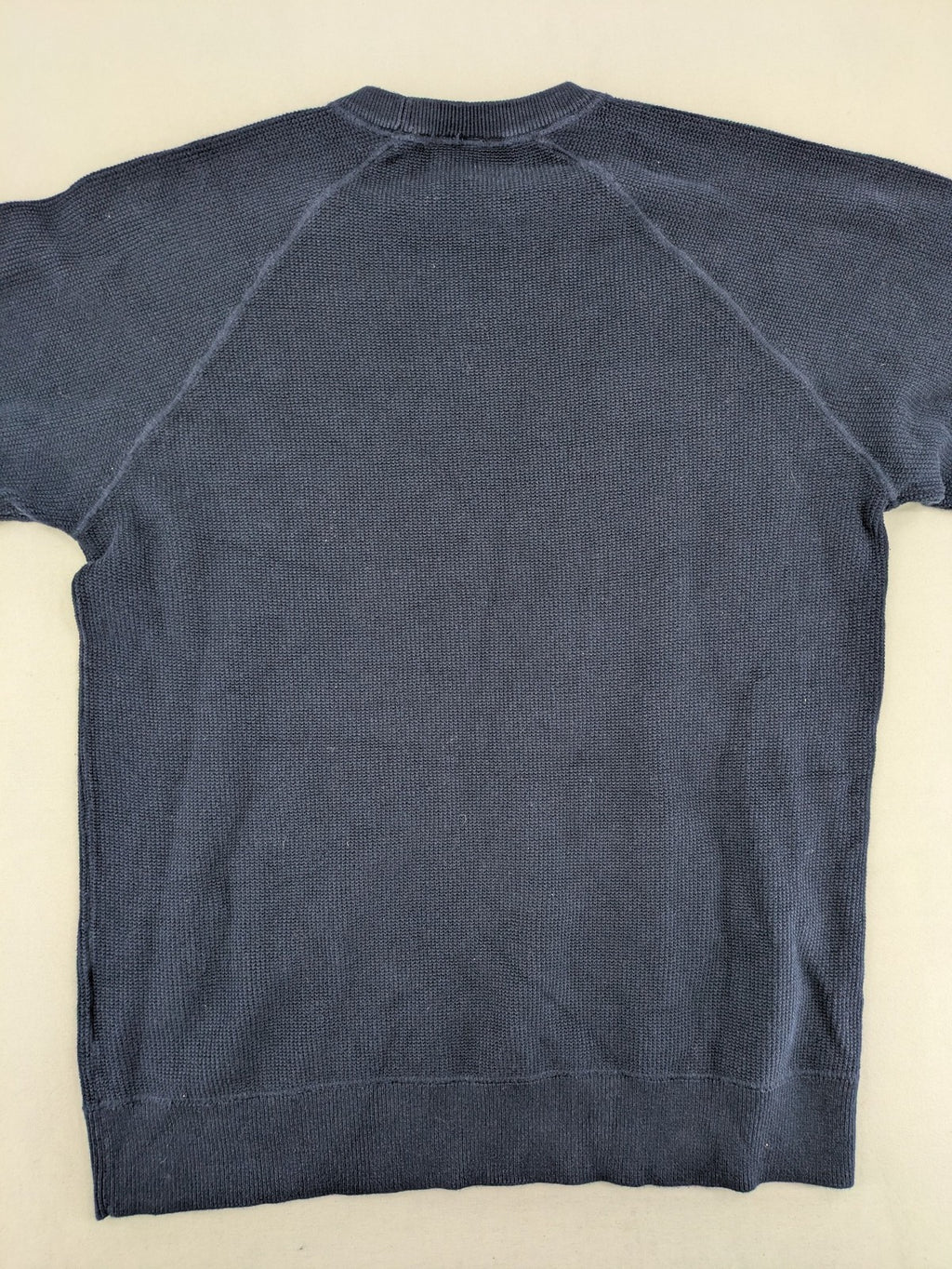 Carhartt navy turtle neck jumper waffle knit texture with subtle logo on sleeve.