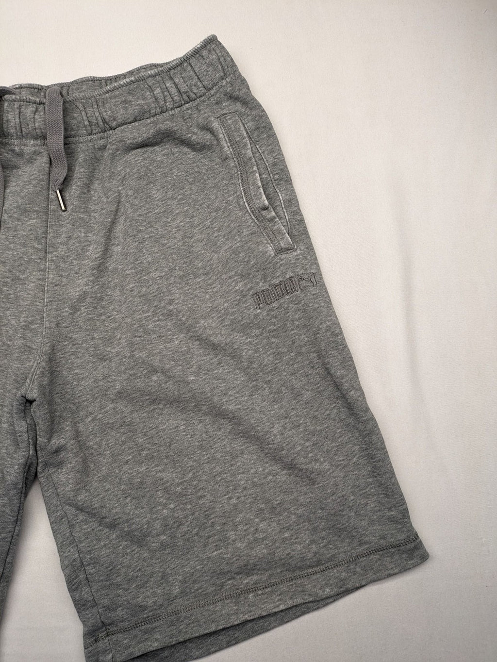 Puma grey sweat shorts with embroidered logo, made from cotton-polyester blend.