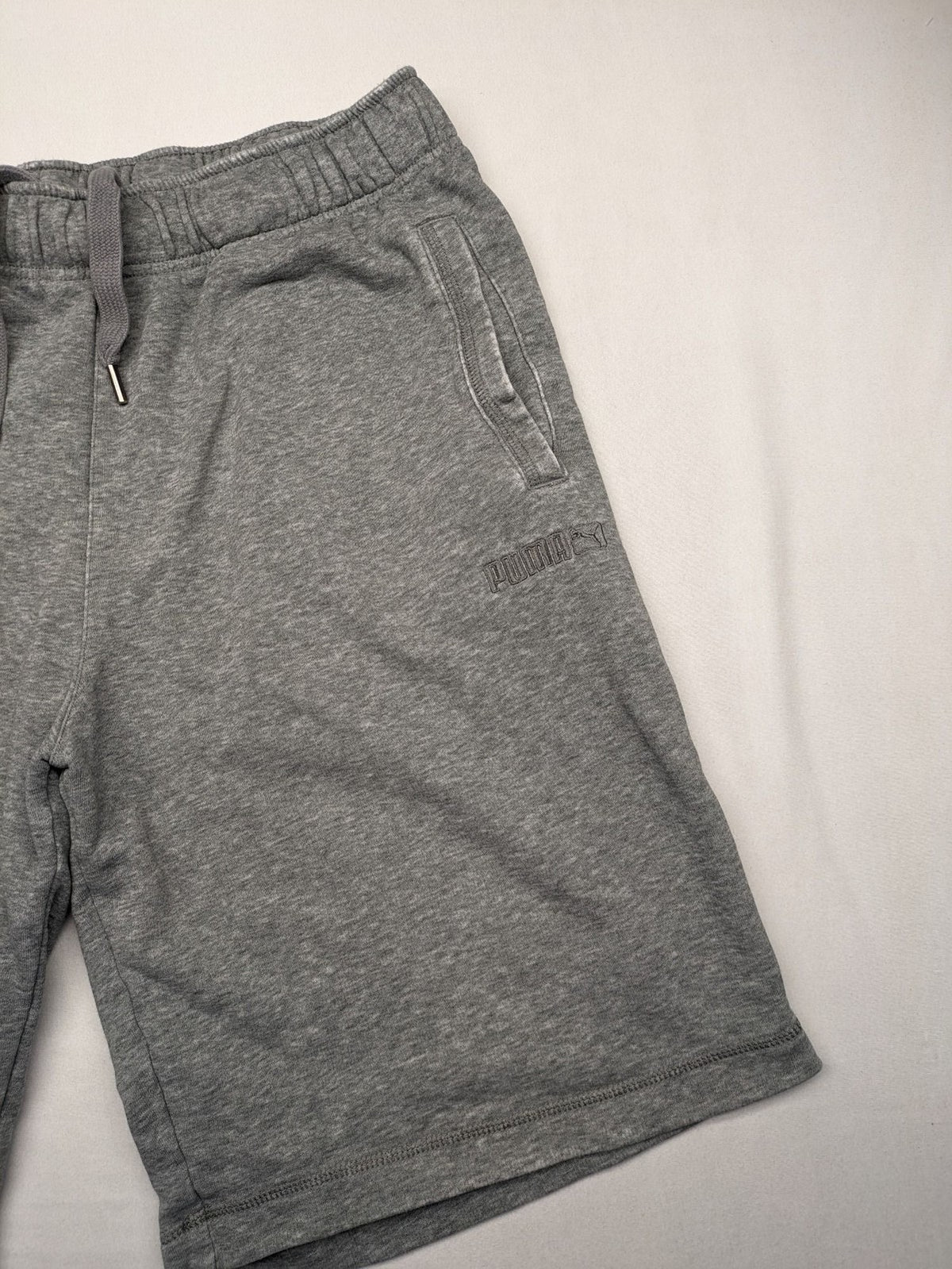 Puma grey sweat shorts with embroidered logo, made from cotton-polyester blend.