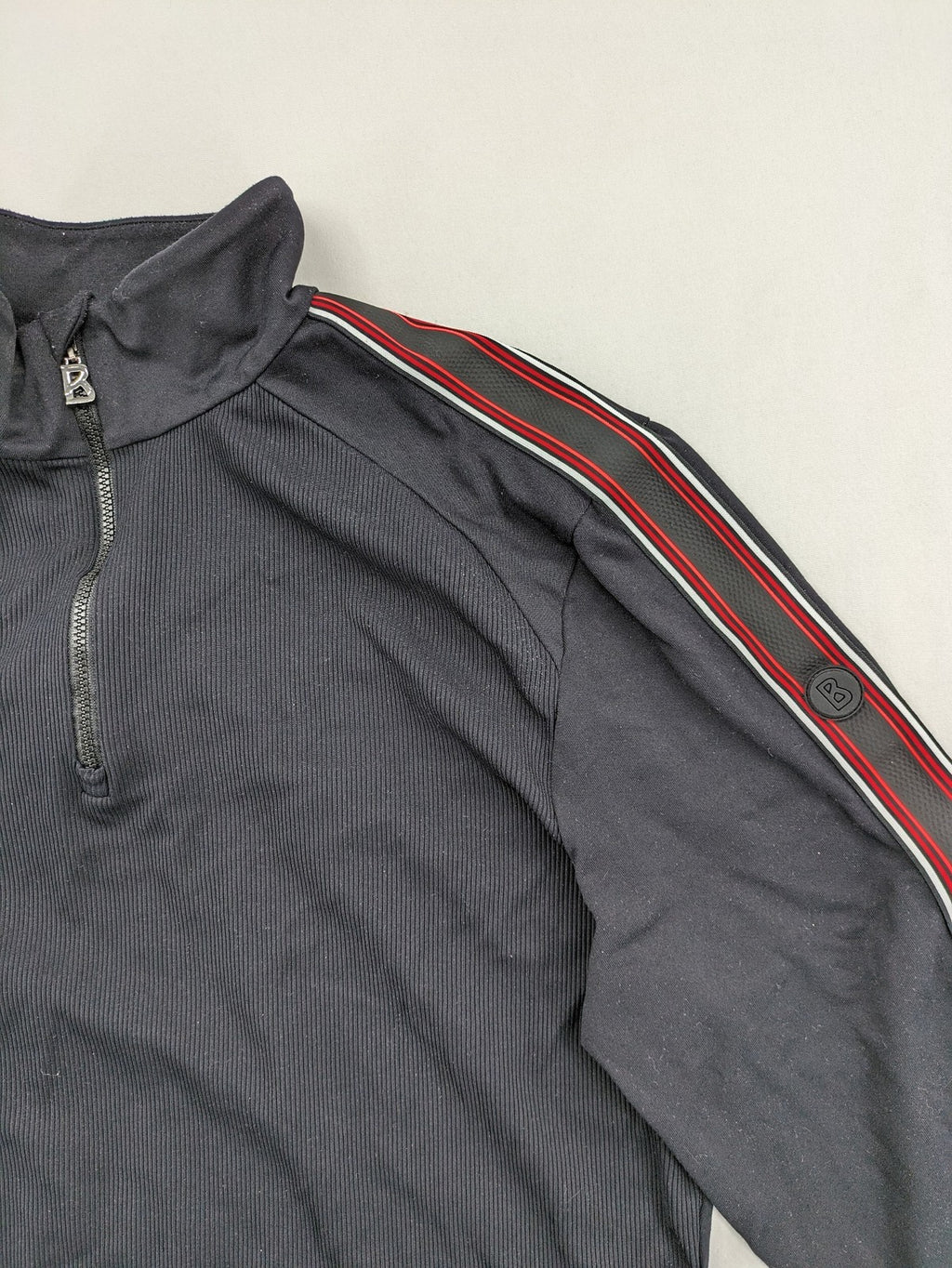 Bogner black turtle neck jumper with red and white striped sleeves and 1/4 zipper.