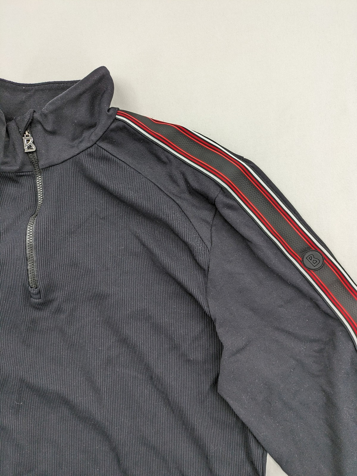 Bogner black turtle neck jumper with red and white striped sleeves and 1/4 zipper.