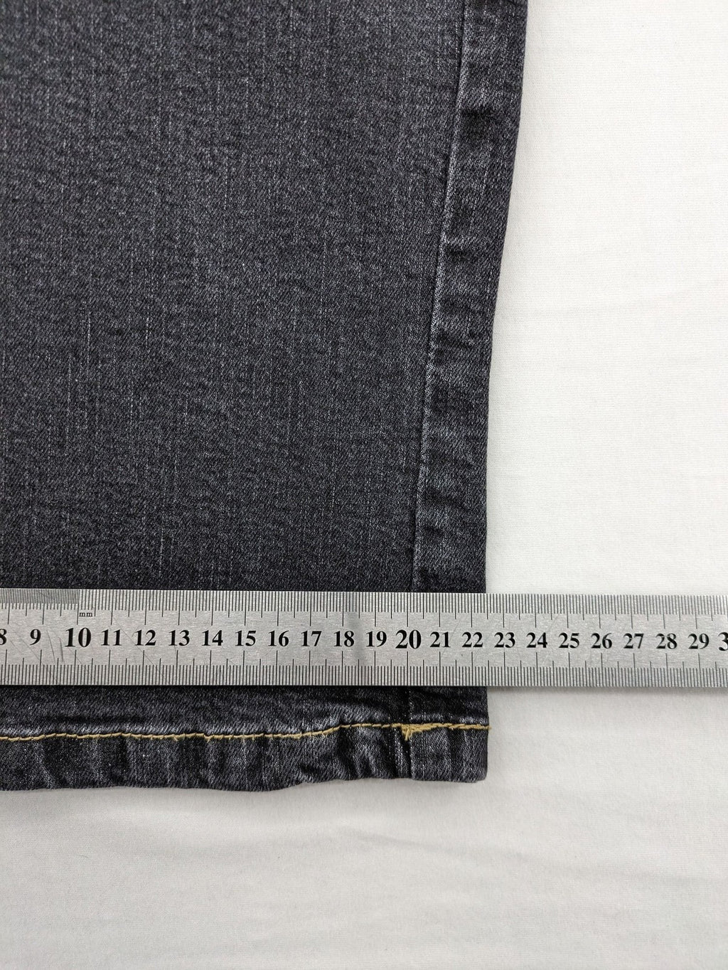 Bootcut grey low rise bootcut jeans five-pocket design with zipper and button closure.
