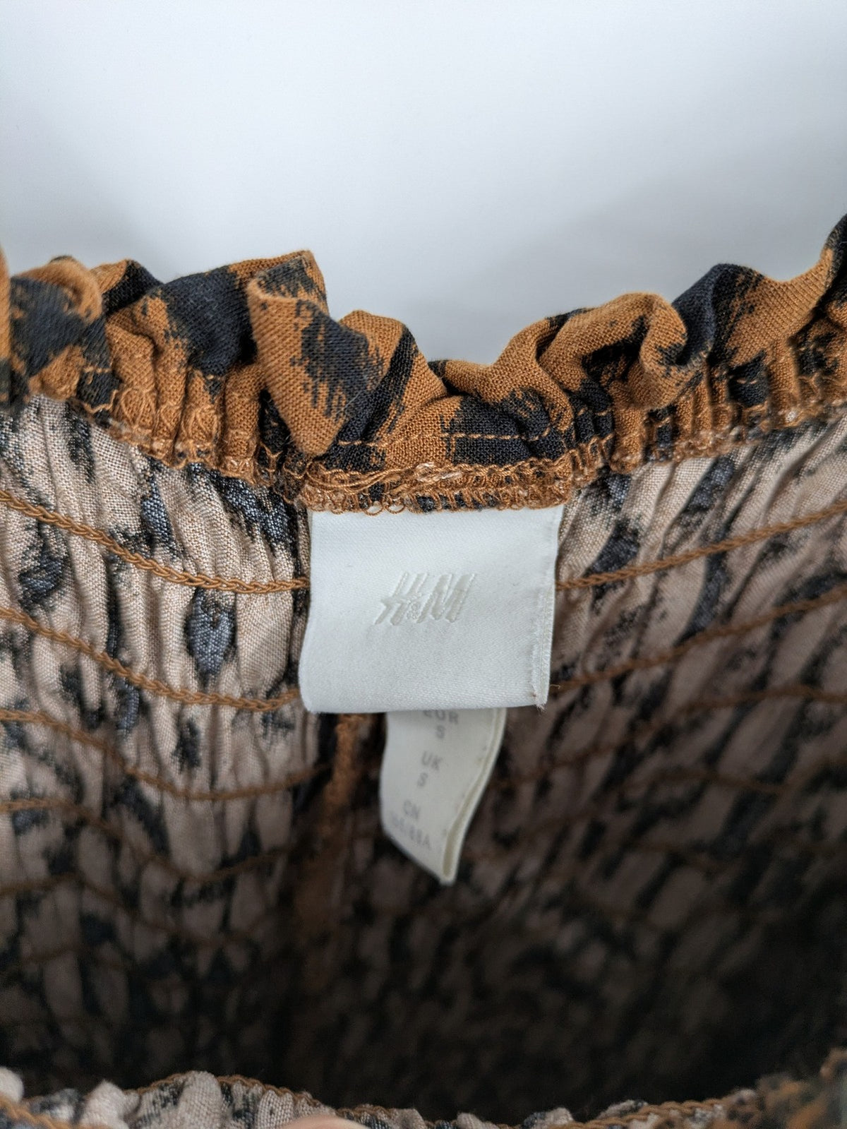 H&M brown and black animal print midi dress with smocked bodice and square neckline.