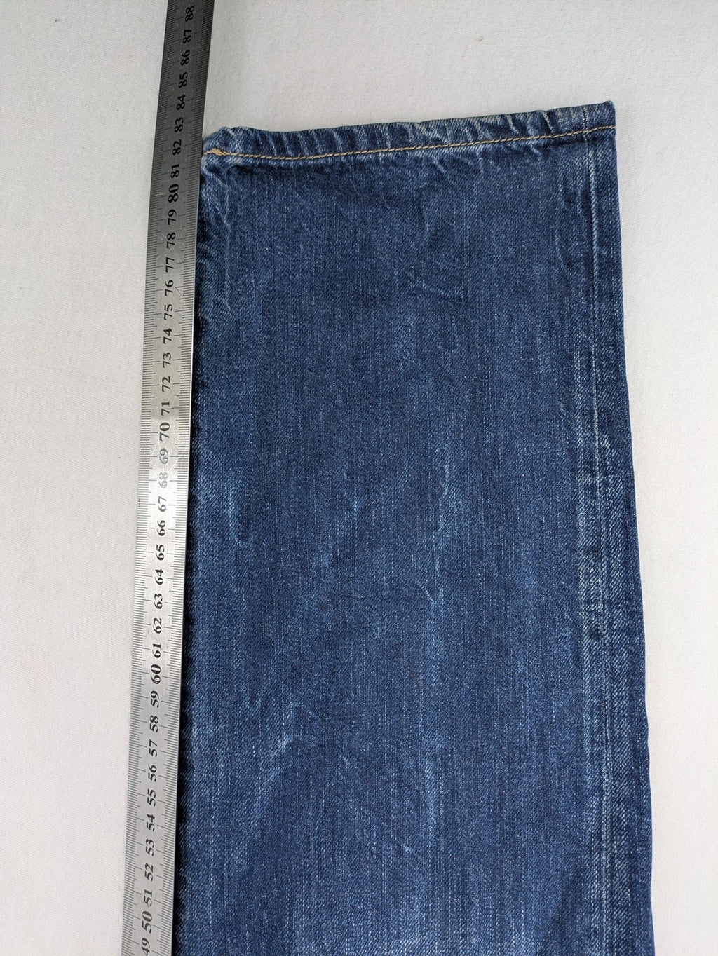 Hilfiger Denim blue straight jeans faded wash with Tommy Hilfiger flag logo on pocket.
