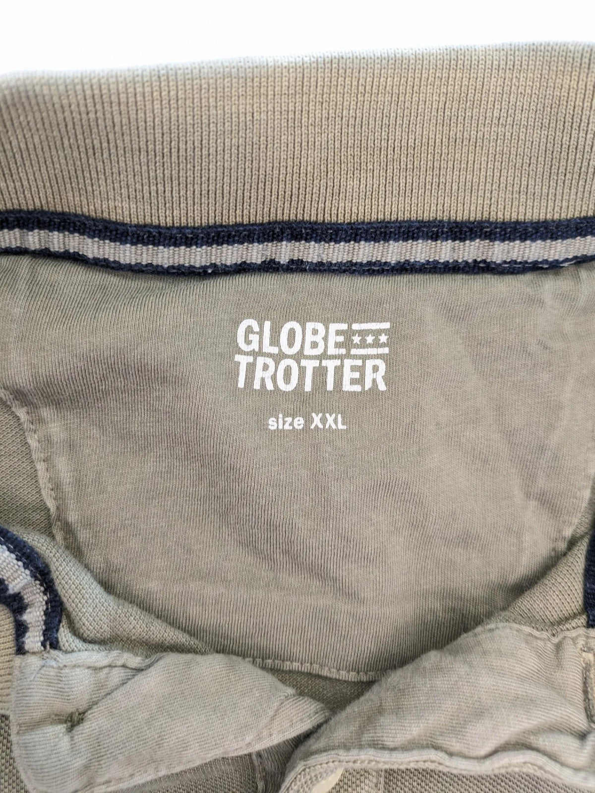 Globe-Trotter beige khaki polo shirt with classic collar and small chest logo.