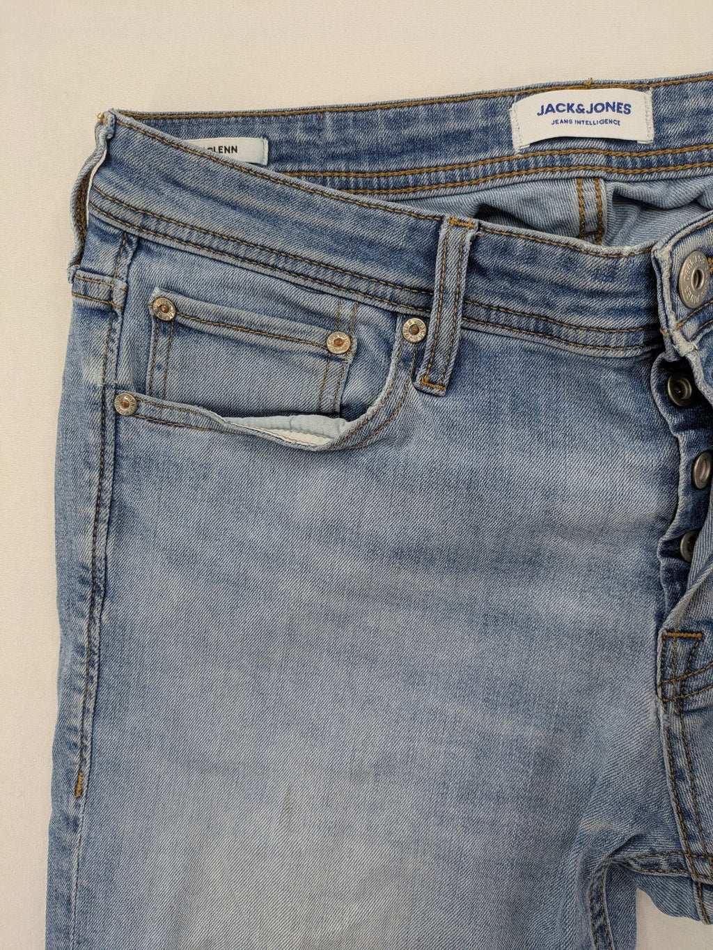 Jack & Jones blue slim jeans with button fly and subtle used look.