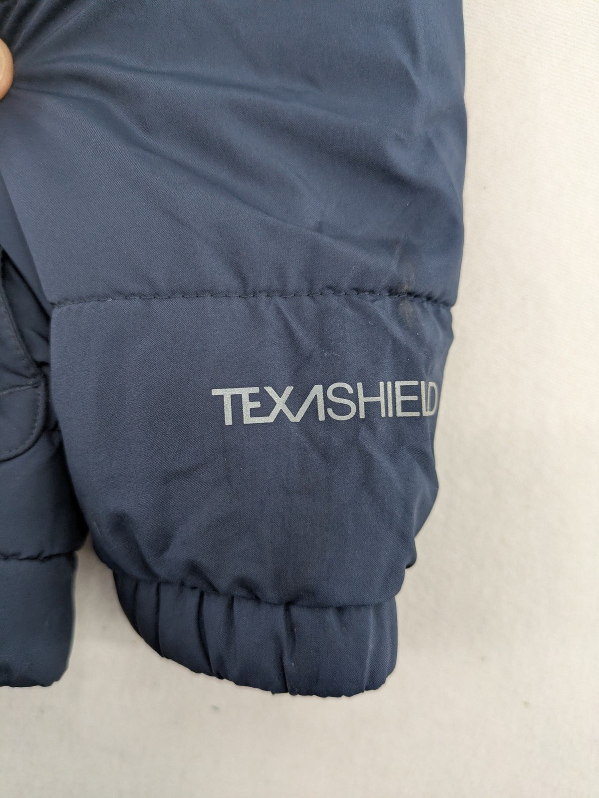 Jack Wolfskin cream and navy puffer coat with quilted design and Sherpa fleece lining.