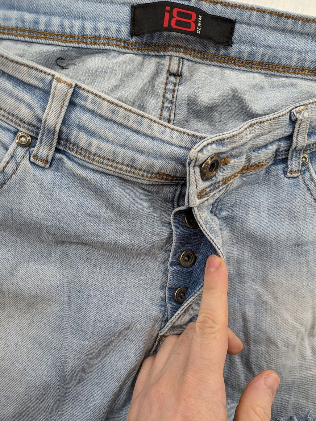 i8 Denim blue straight jeans destroyed look with frayed hems and classic button fly.