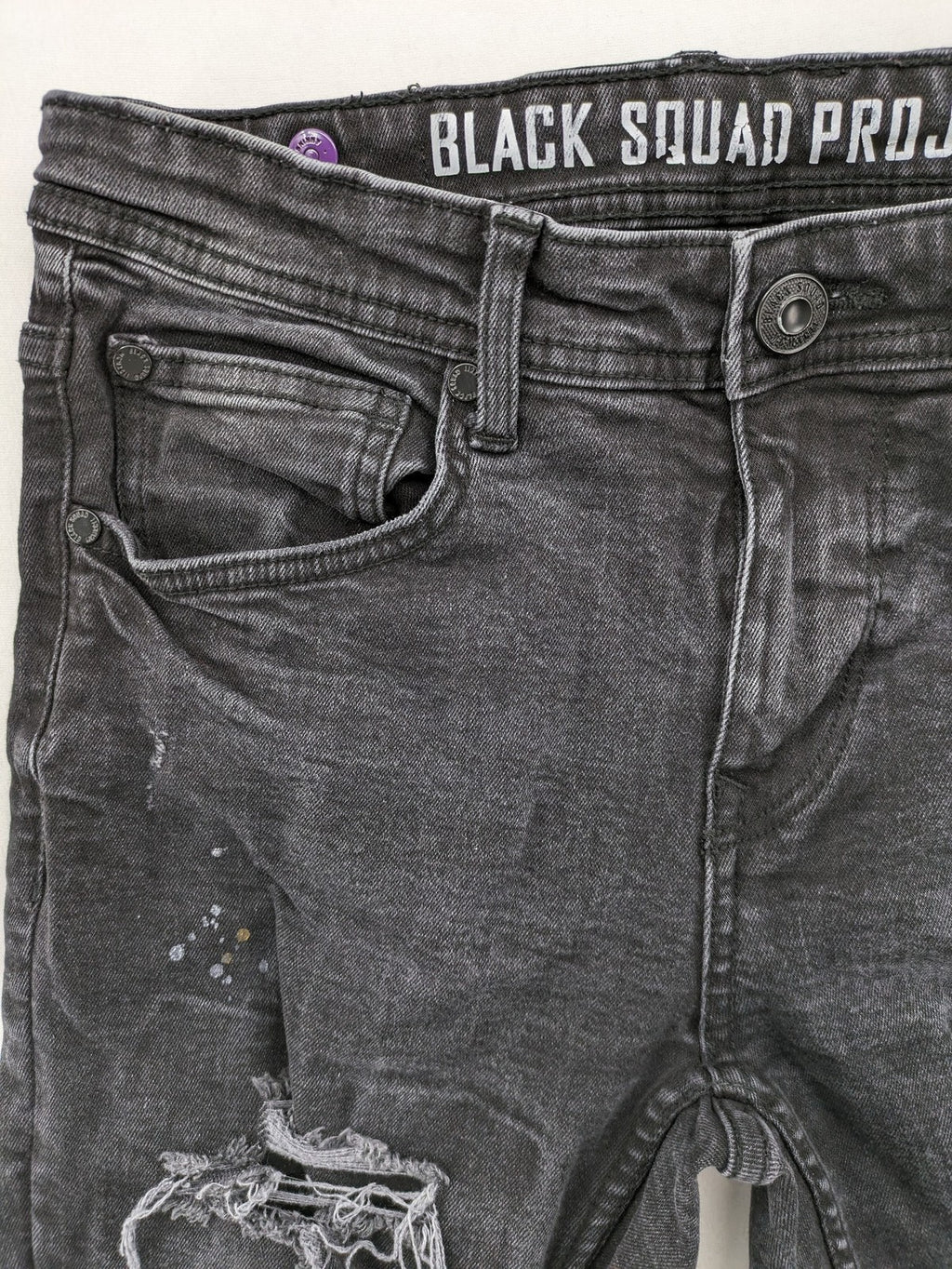Black Squad skinny fit jeans black distressed ripped design with subtle paint splatter.