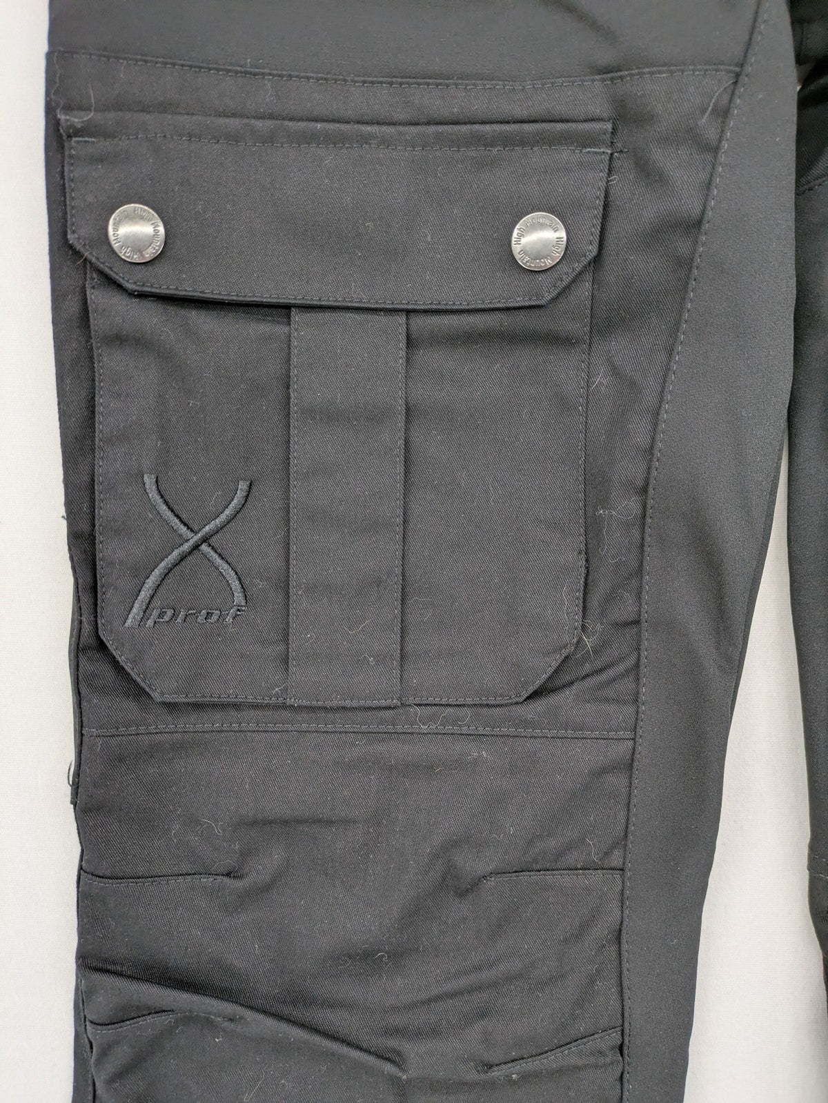 High Mountain black cargo pants with multiple pockets and durable stretch material.