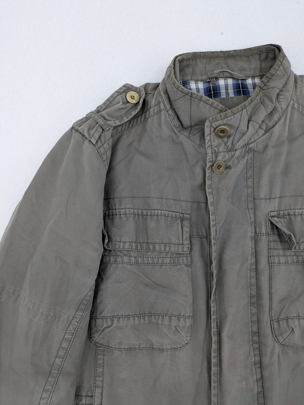 Walbusch khaki military jacket with checkered blue-white lining and multiple pockets.