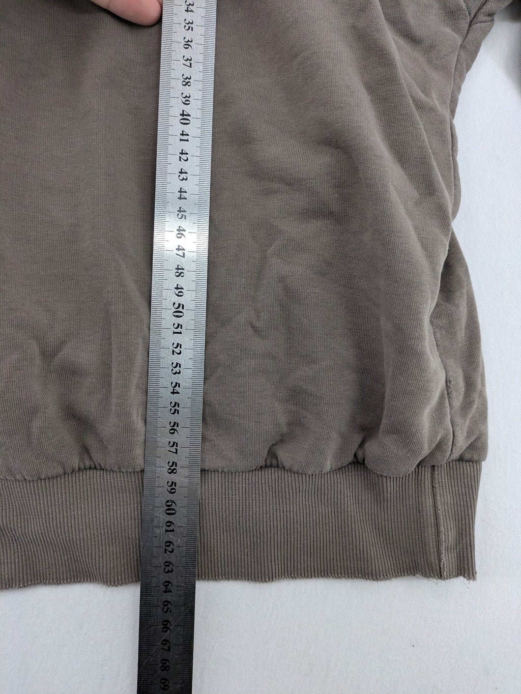 Mosquito grey hoodie with distressed cuffs and subtle logo on the chest.