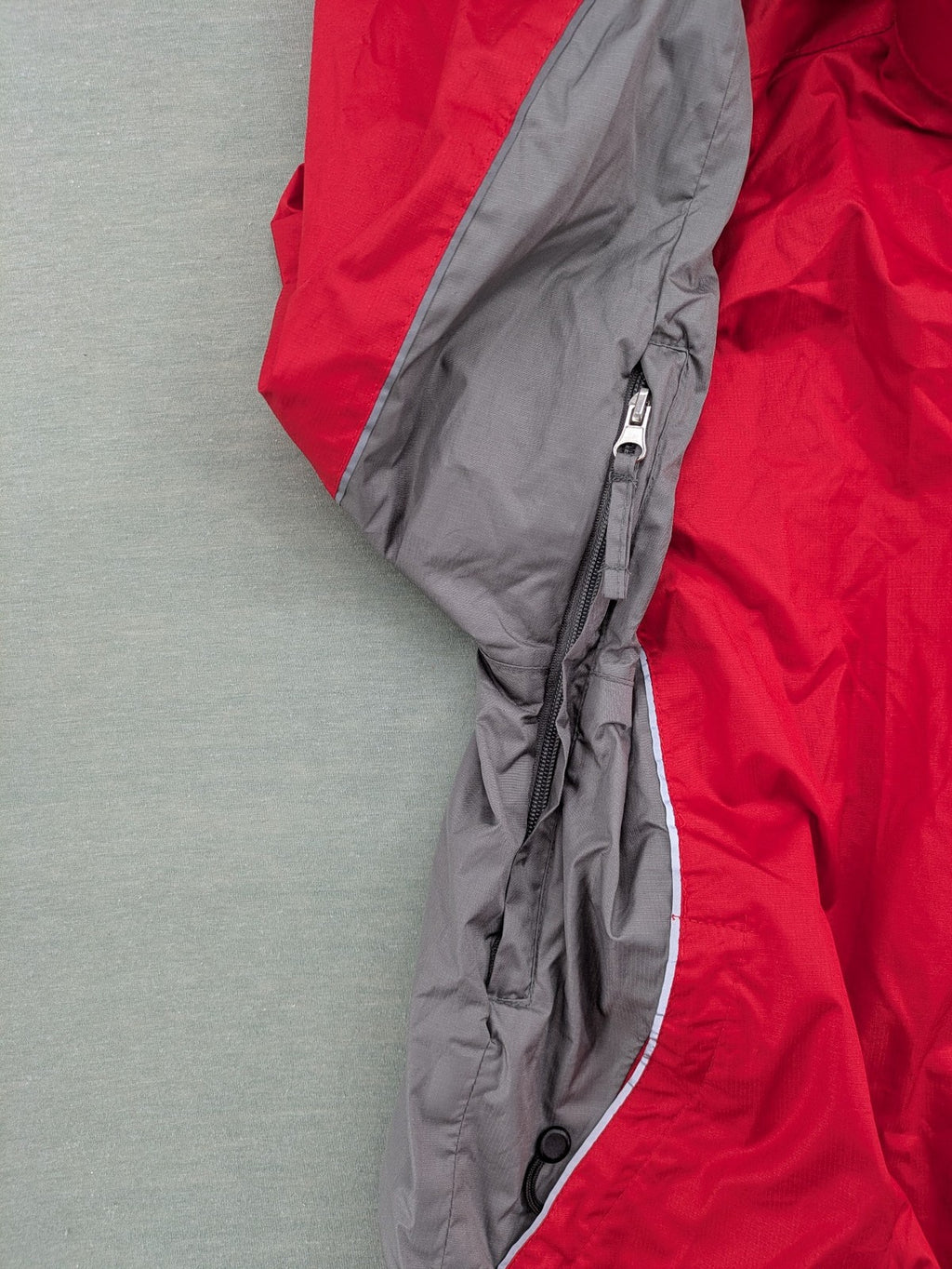 Movement Session grey and red windbreaker jacket with colorblock pattern and full zip.