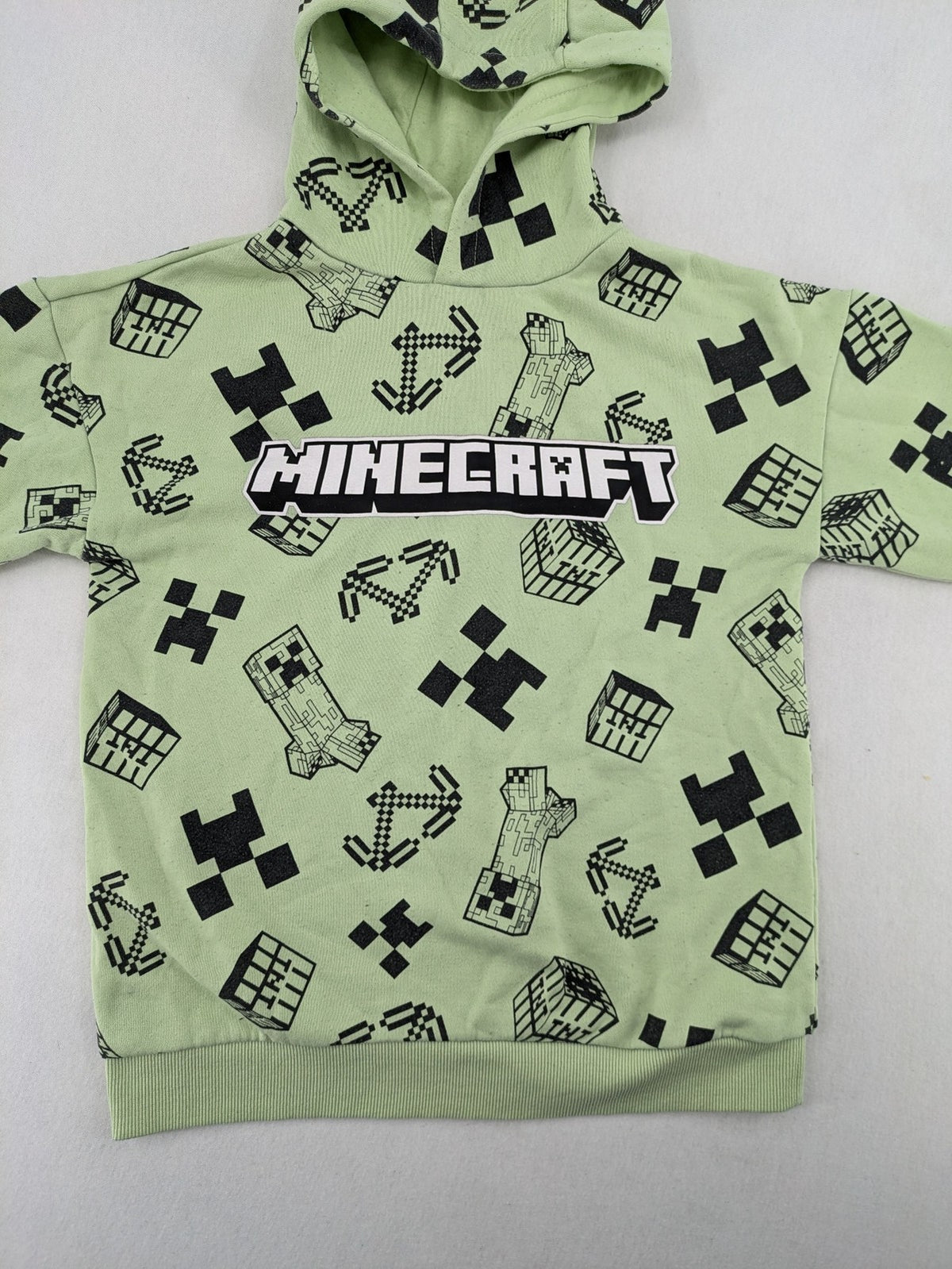 Minecraft zip-through hoodie green all-over print with Creeper and logo details.