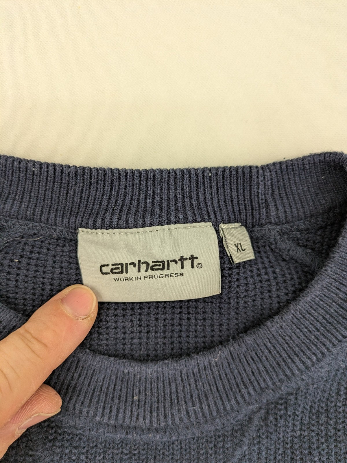 Carhartt navy turtle neck jumper waffle knit texture with subtle logo on sleeve.