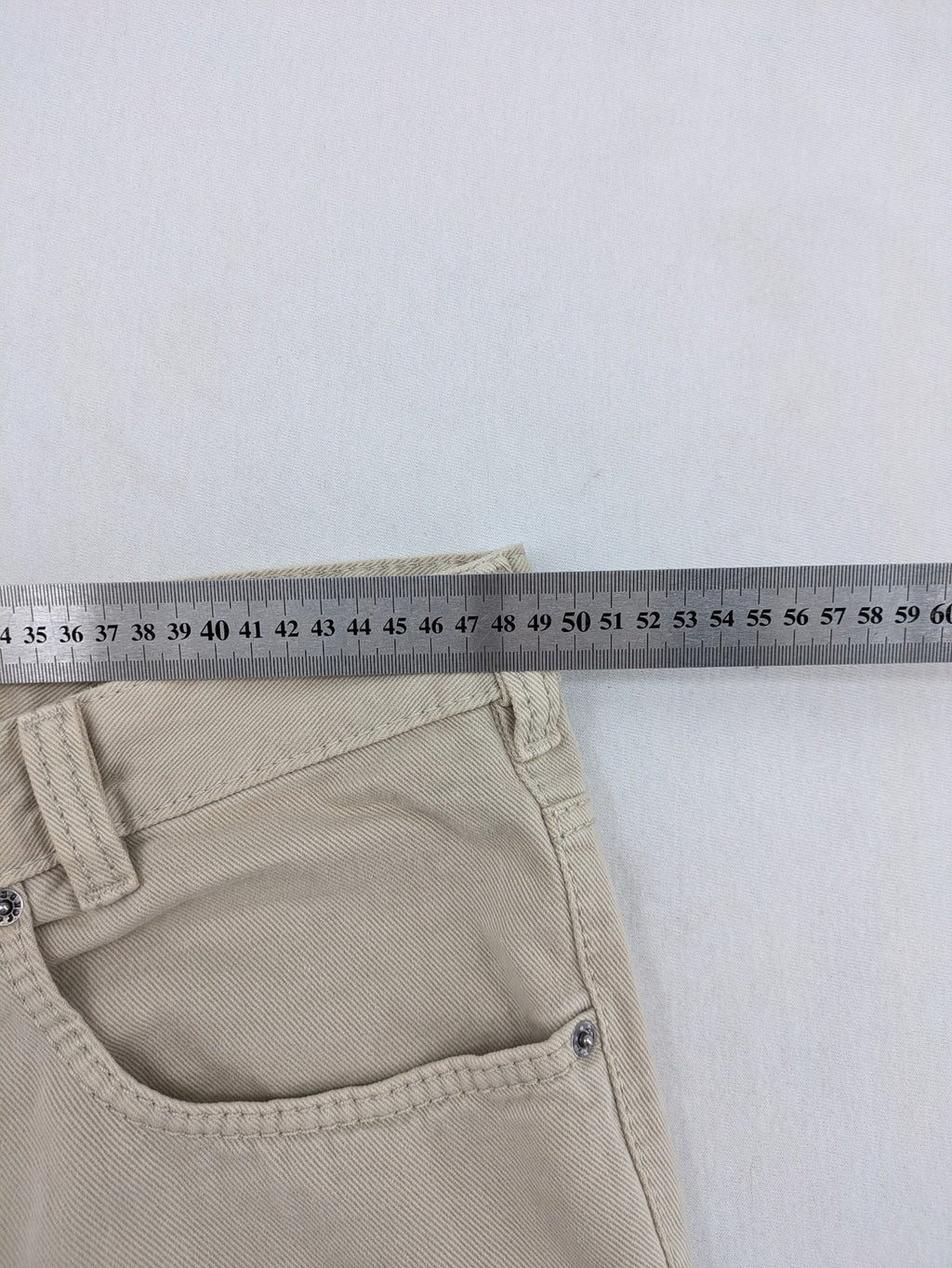 Joker beige straight jeans 5-pocket design with zipper and button closure.