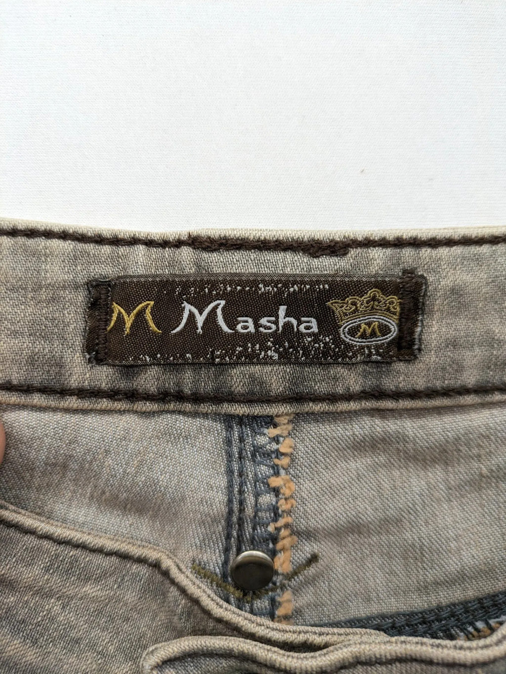 Masha khaki straight jeans with rhinestone embellishments and decorative stitching.