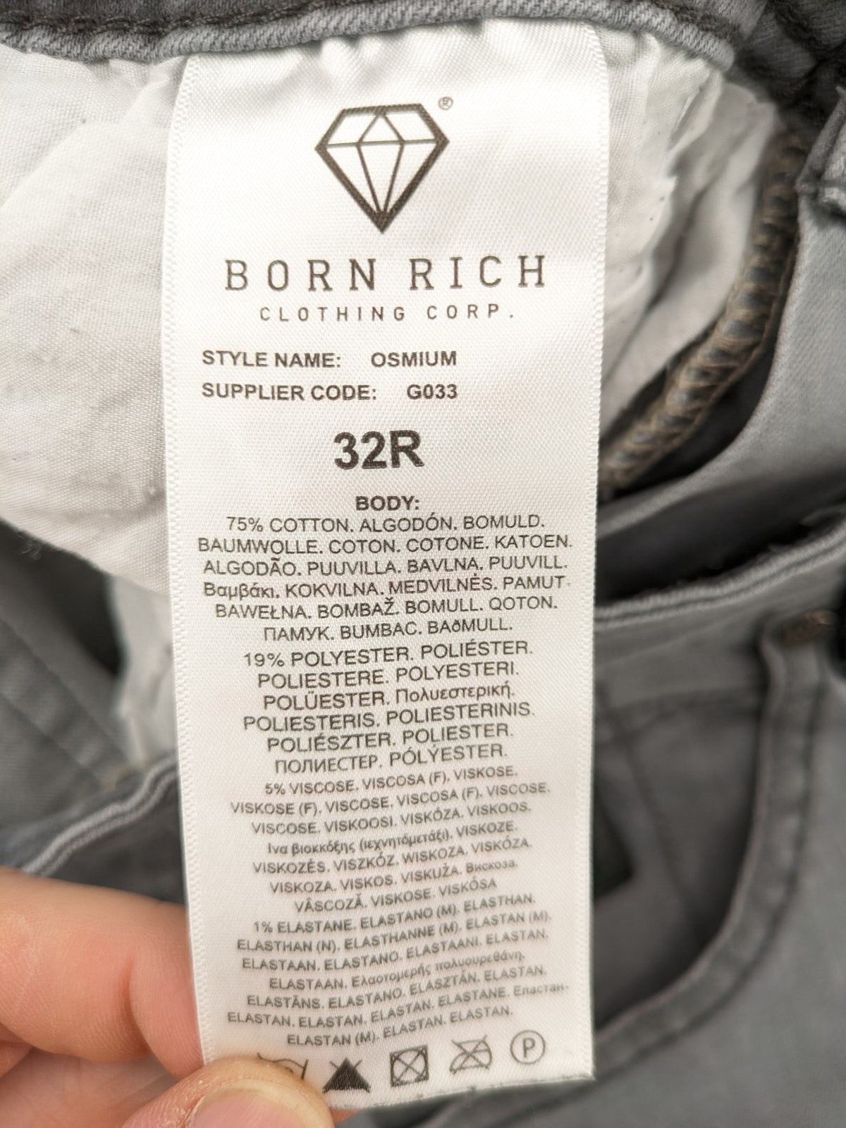 Born Rich grey slim fit jeans with logo patch and washed denim texture.