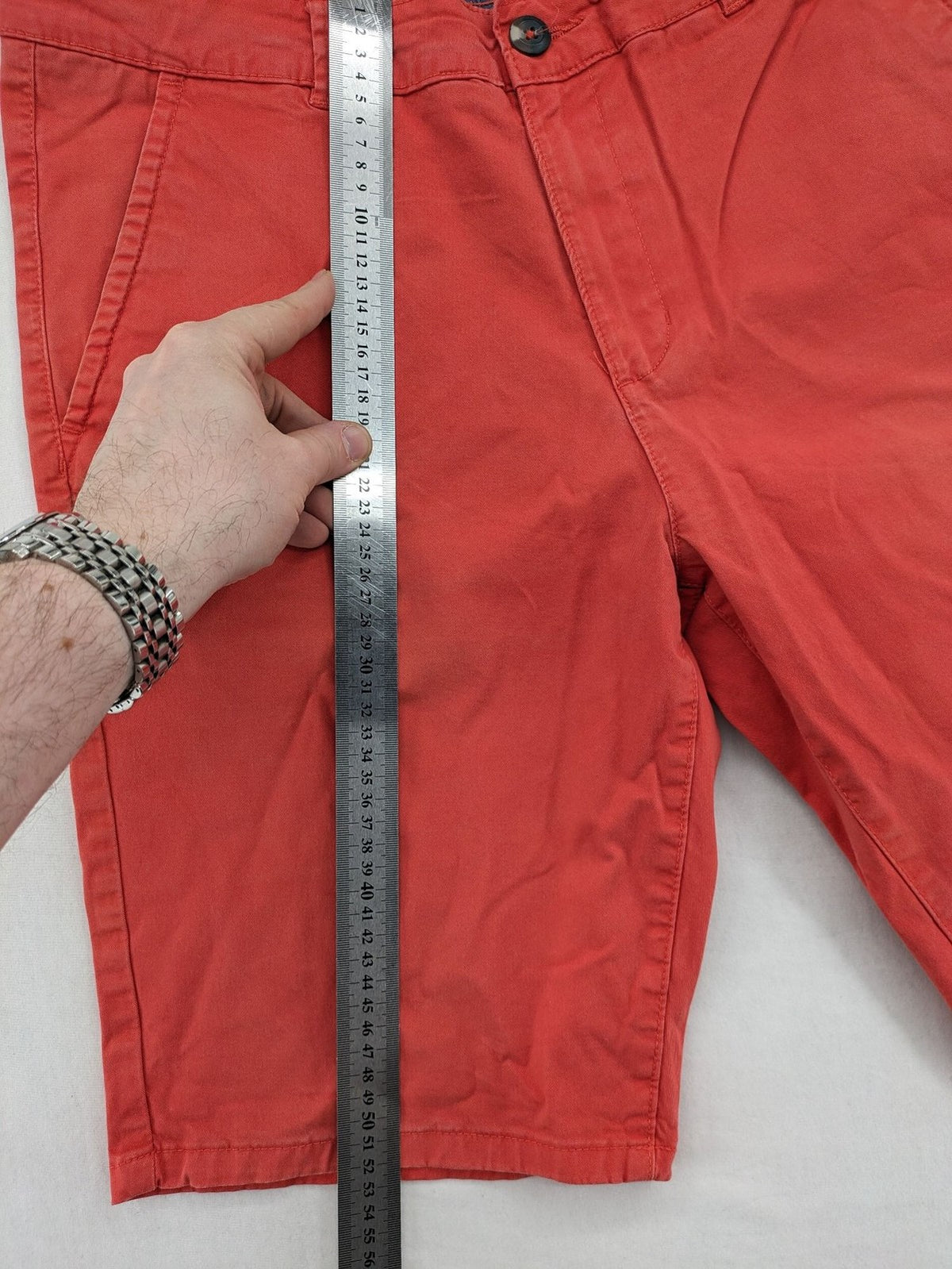 Chino orange shorts flat front with Est. 1921 label and comfortable fit.