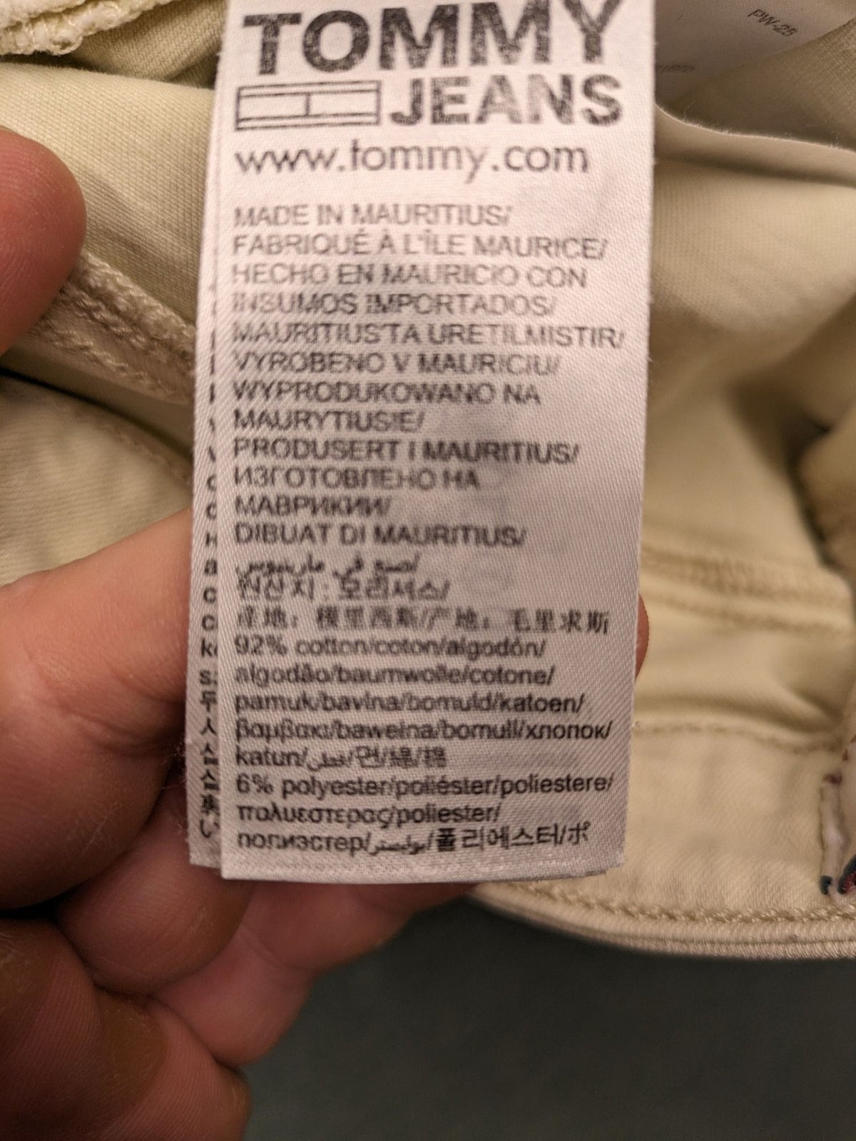 Tommy Jeans beige high rise skinny ankle jeans with logo patch and stretch fabric.