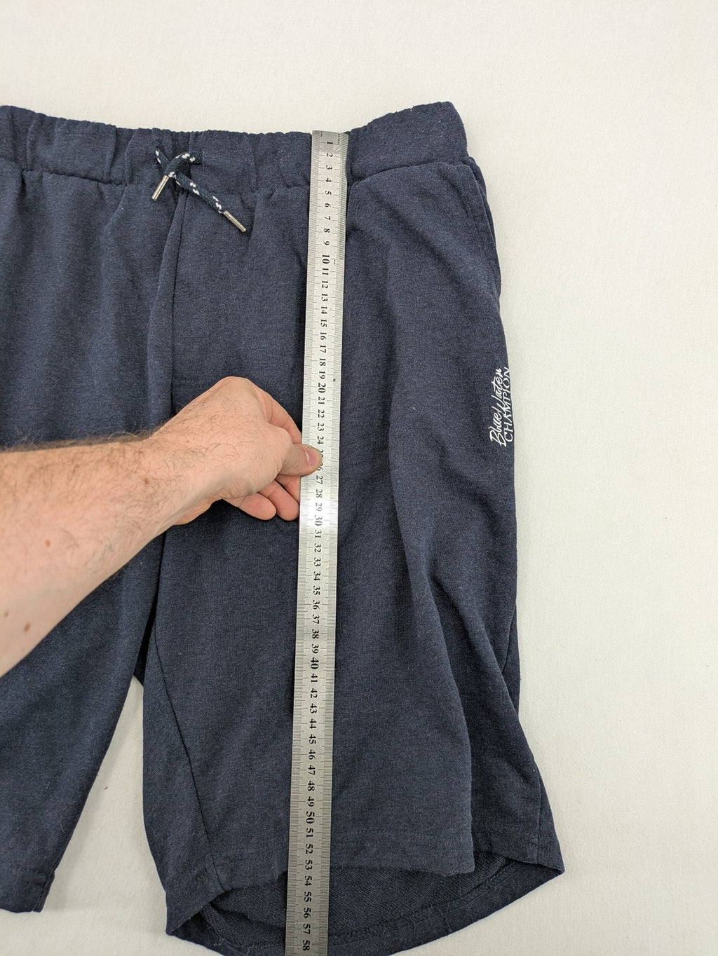 Livergy blue sweatshorts with embroidered "Blue Water Champion" logo and adjustable drawstring.