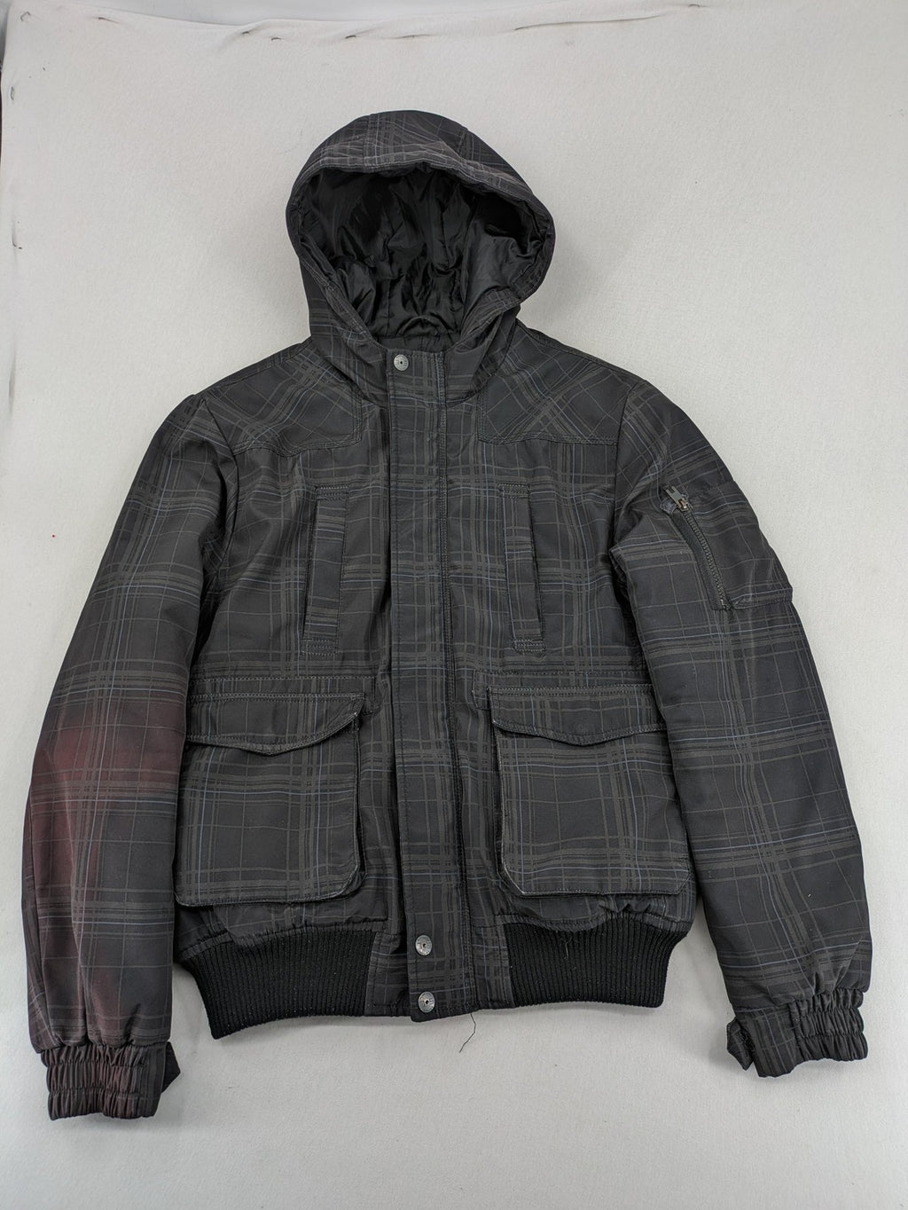 Jack & Jones grey checkered winter jacket with hood, quilted lining, and zip closure.
