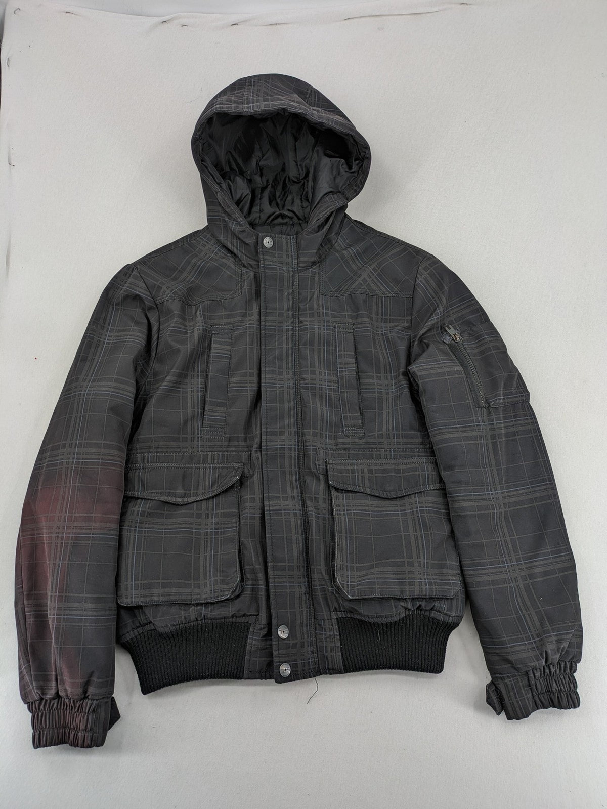 Jack & Jones grey checkered winter jacket with hood, quilted lining, and zip closure.