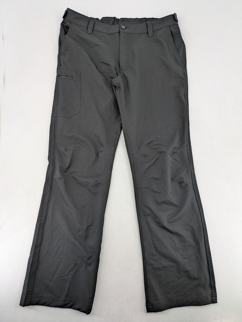 Outdoor grey trekking pants with zippered cargo pockets and durable stretch fabric.