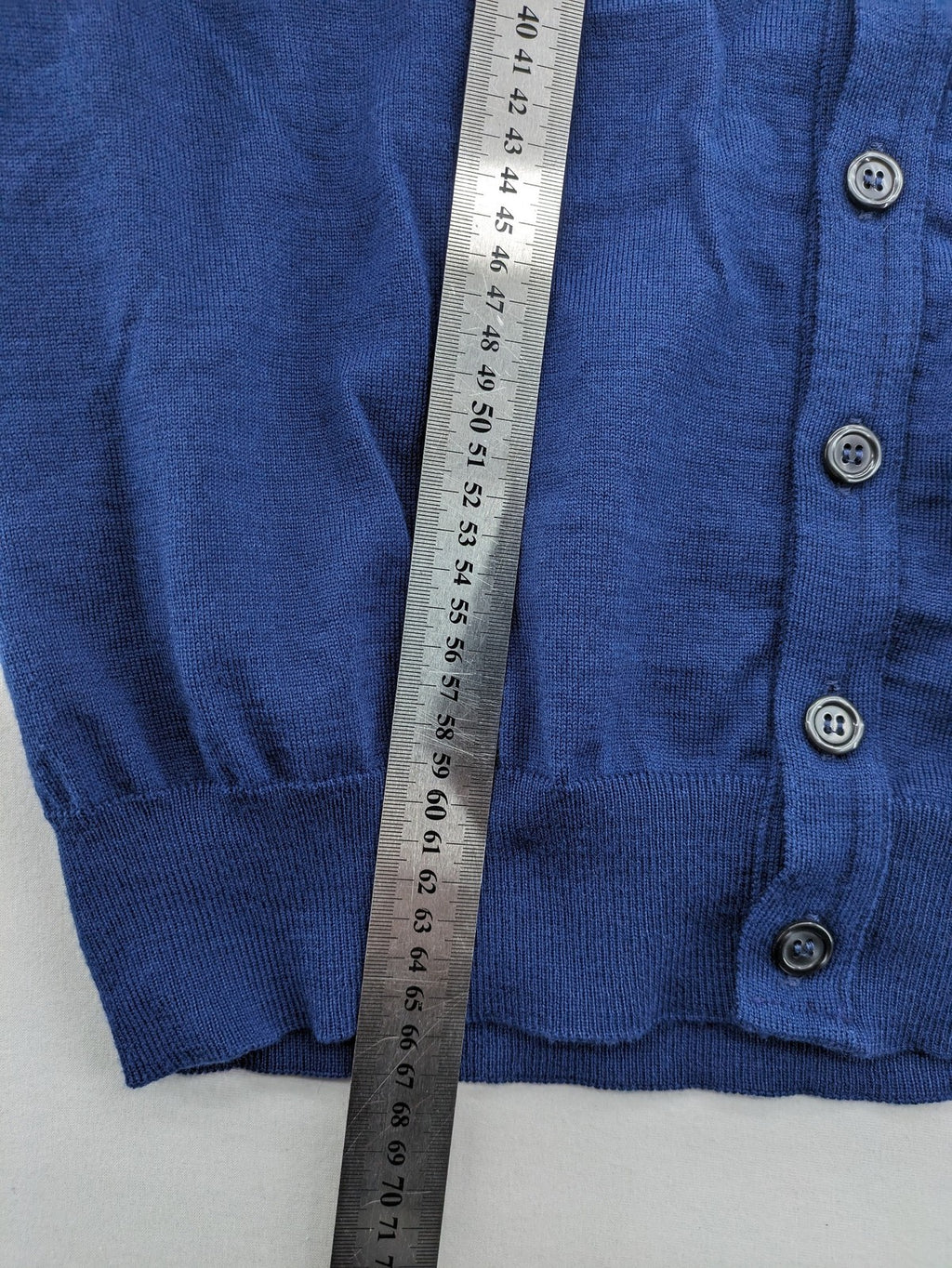Montechiaro blue turtle neck jumper with V-neck, button placket, and sleeveless design.