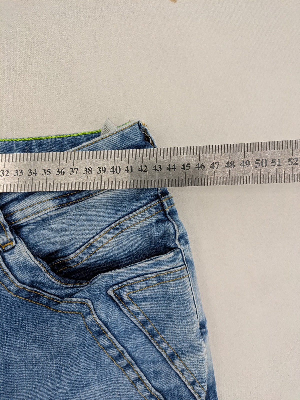 Street One blue straight jeans with green patterned cuffs and button fly detail.