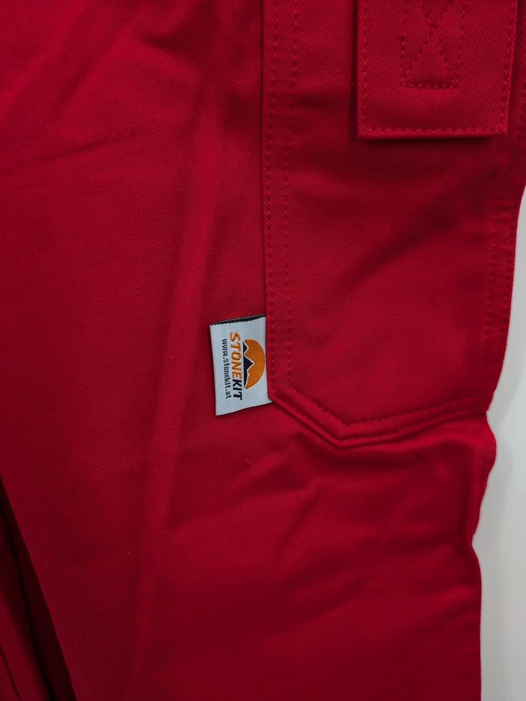 Stonekit red work overalls cotton with adjustable straps and multiple cargo pockets.
