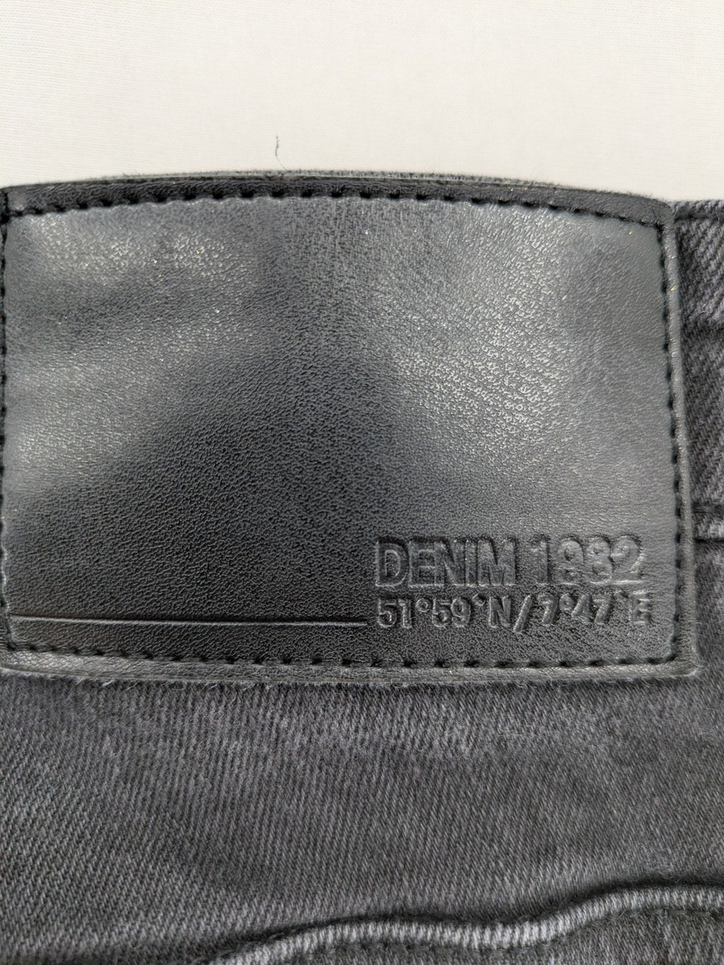 Denim 1982 grey slim fit jeans with ripped knee detail and distressed finish.
