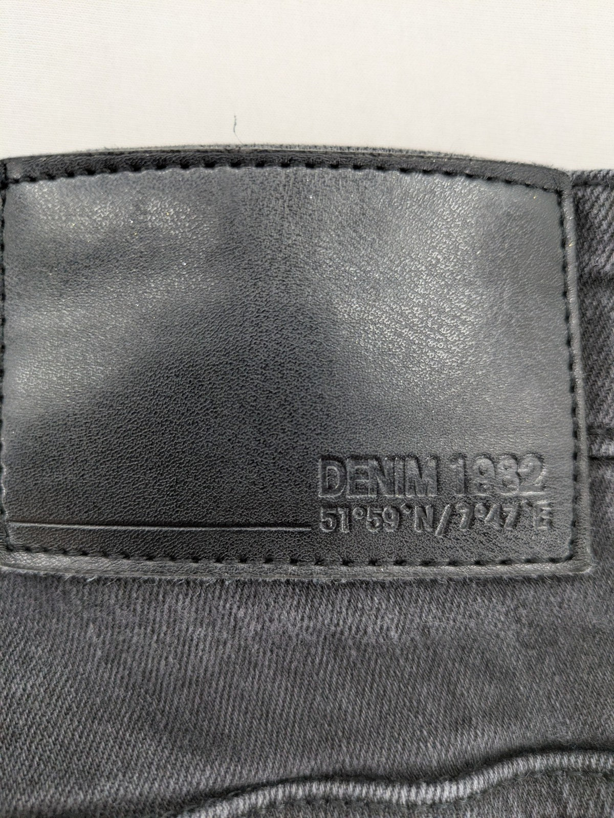 Denim 1982 grey slim fit jeans with ripped knee detail and distressed finish.