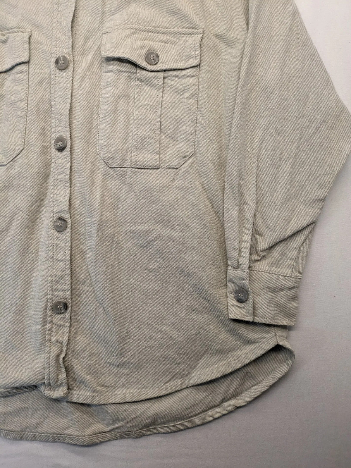 H&M beige overshirt jacket, classic collar, button-down front, two chest pockets, cotton material.