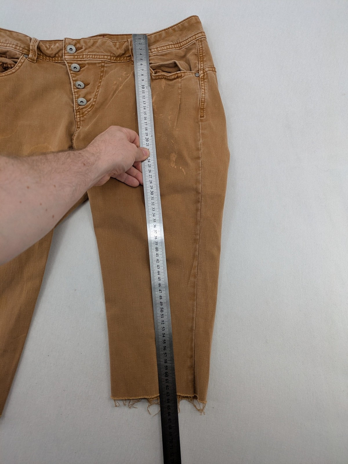 Buena Vista beige capri jeans with frayed hem and button fly detail.